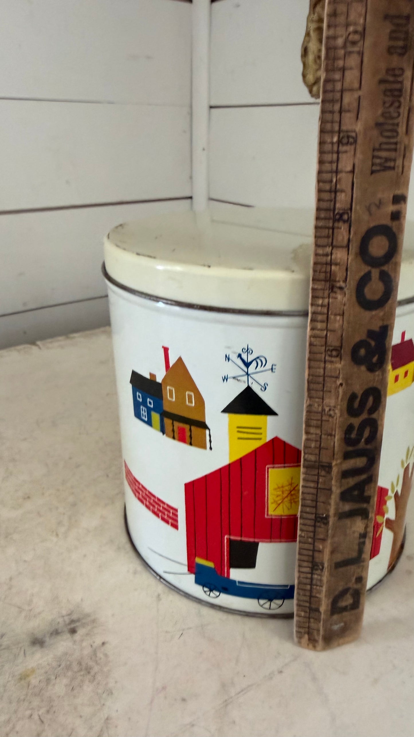 Vintage tin canister with red barn on it
