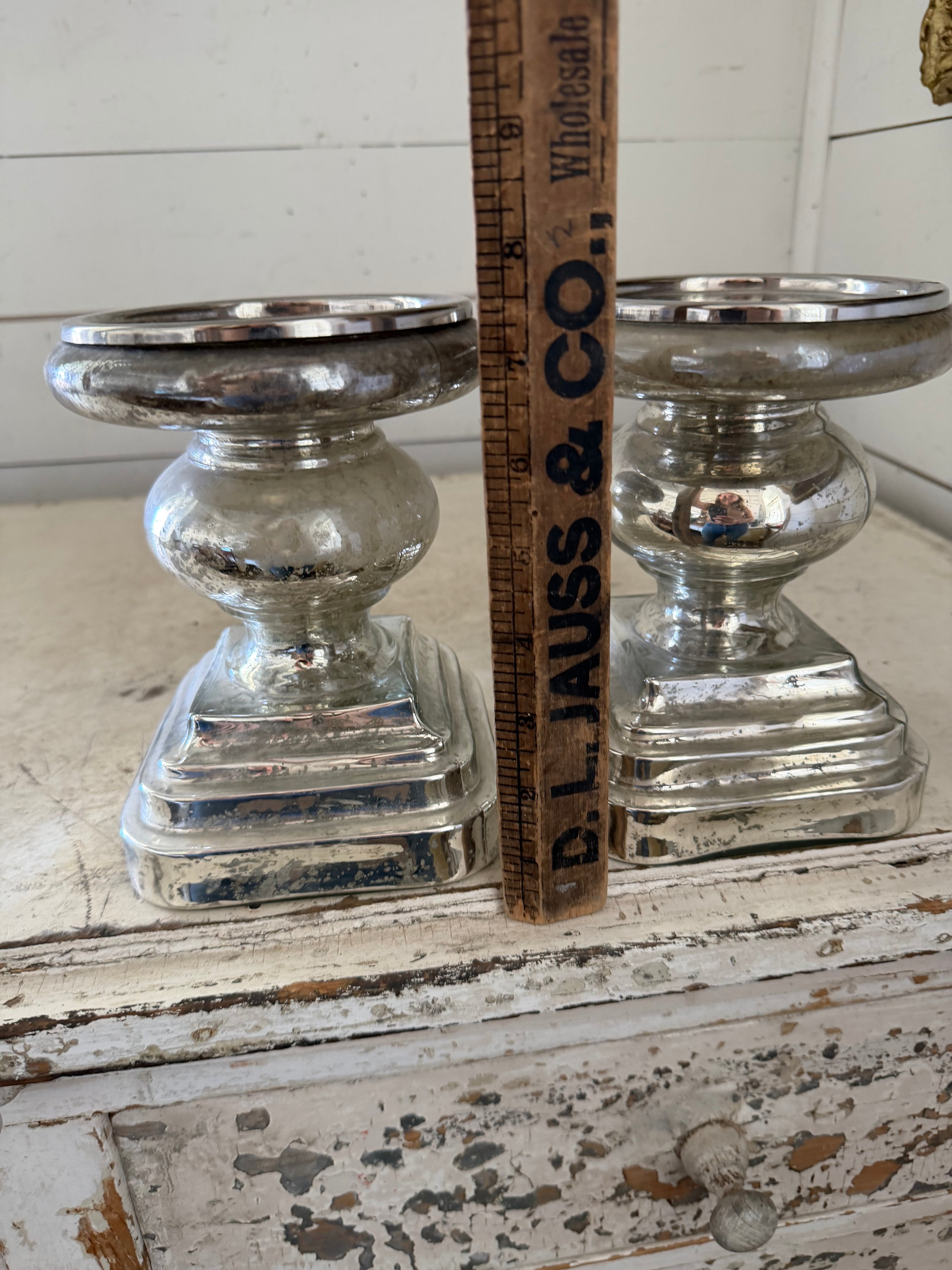 Set of mercury glass  finished candlestick holder features a traditional turned baluster design