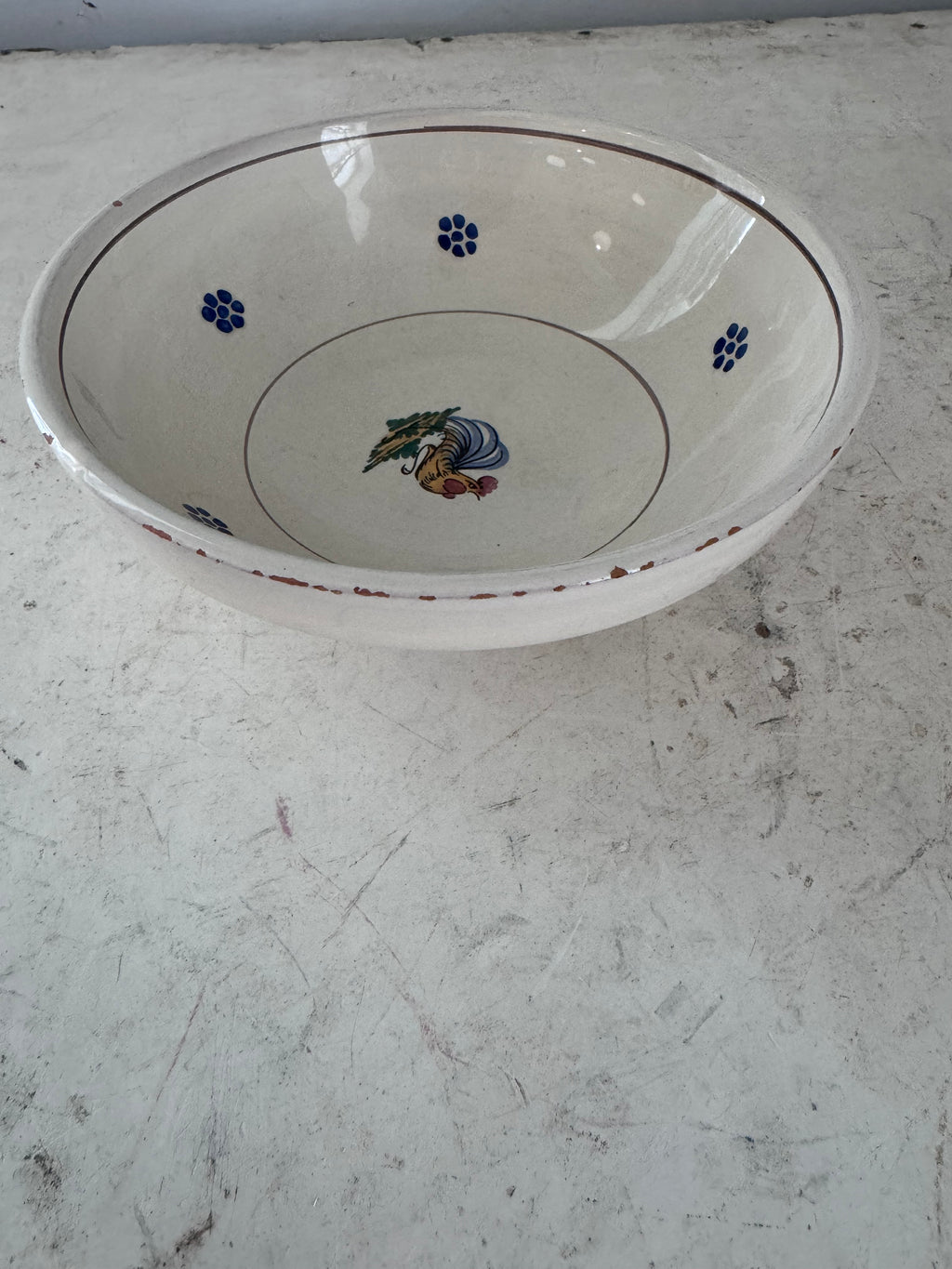 Small enameled terracotta bowl has chips - sold separately