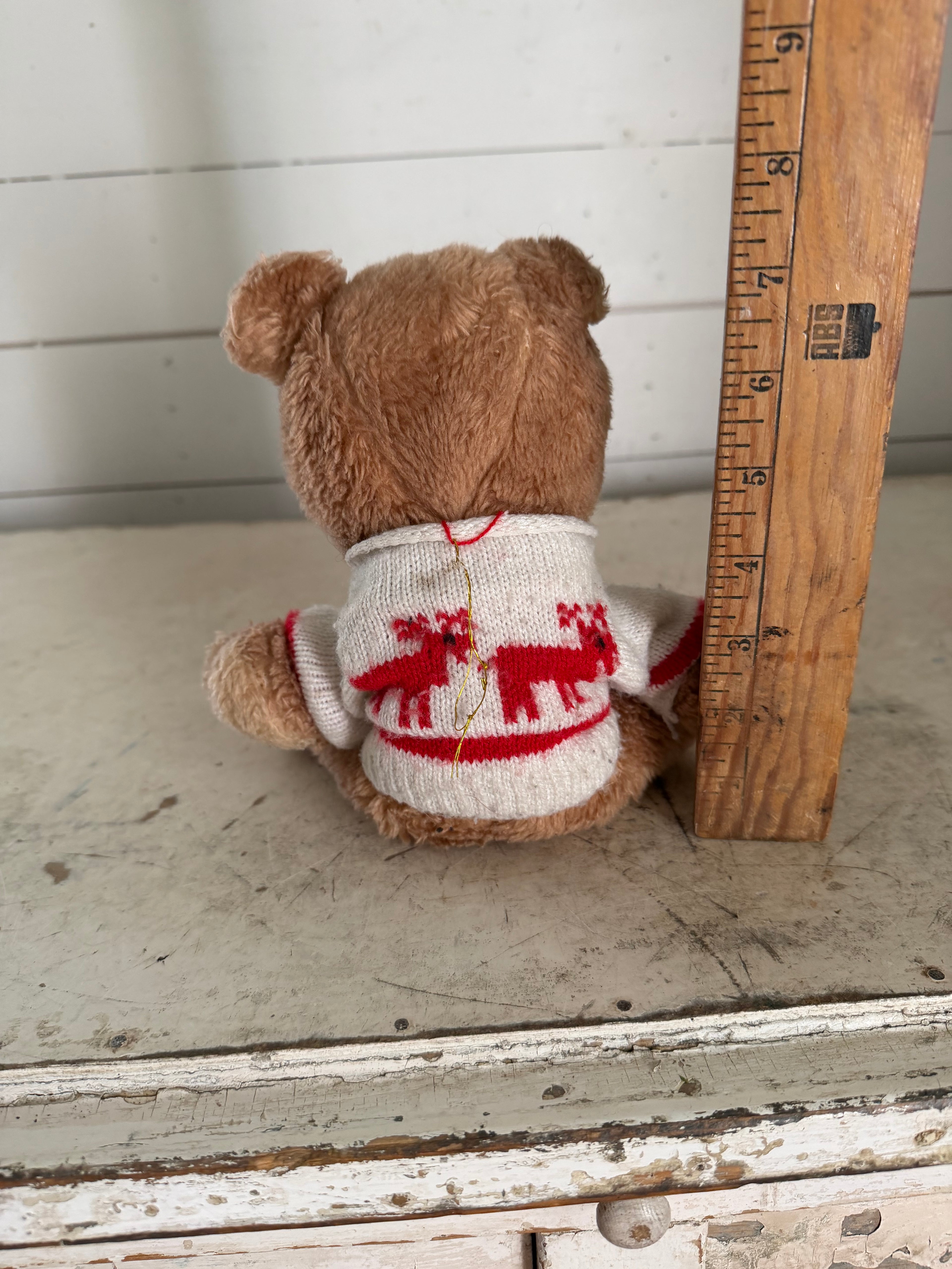 Vintage teddy bear with reindeer sweater