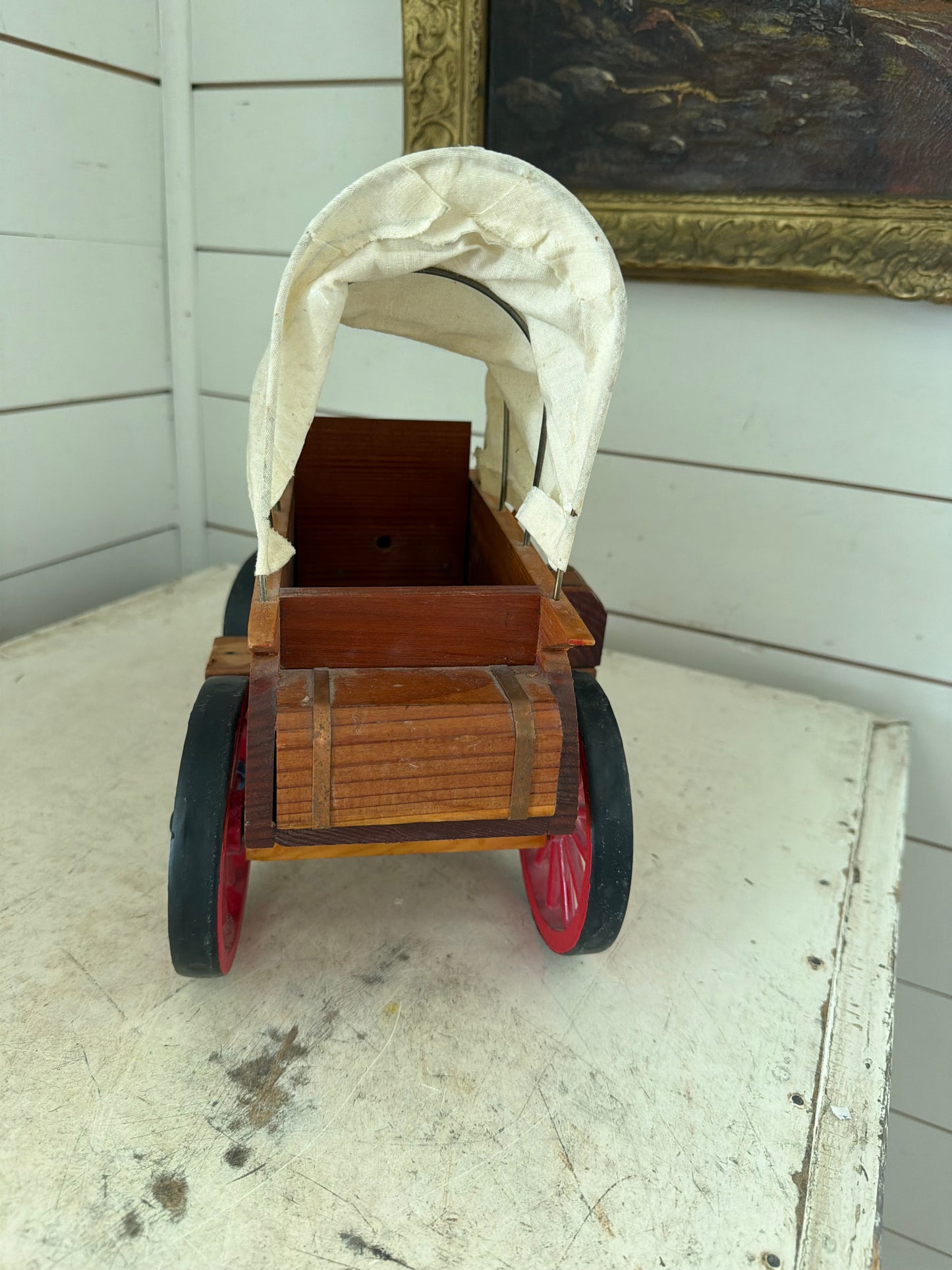 Vintage Wooden Folk Art Covered Wagon Pull Toy featuring distinct red-painted wheels
