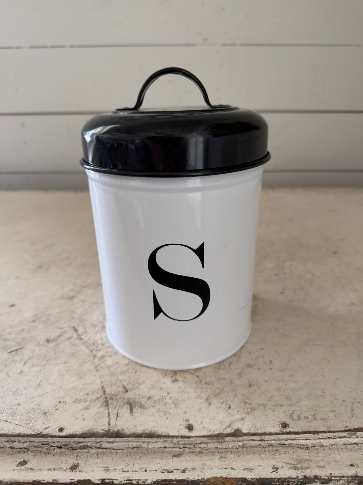 Metal enamel canister with an S on it will get makeover