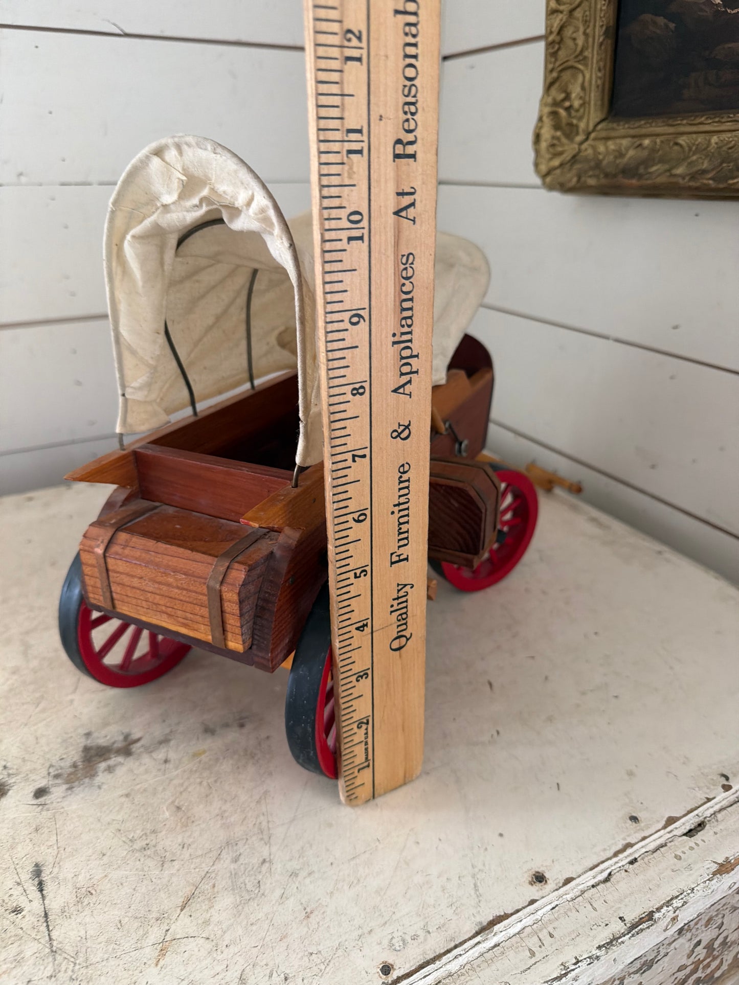 Vintage Wooden Folk Art Covered Wagon Pull Toy featuring distinct red-painted wheels