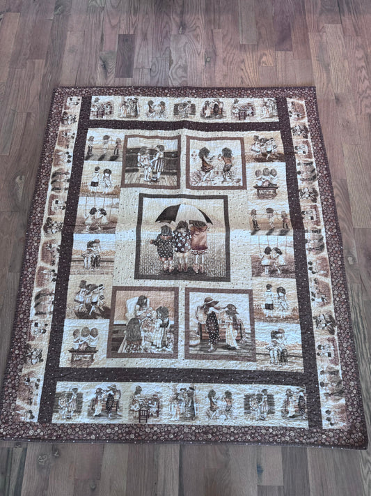 Twin size brown quilt with itch prints of Children Playing