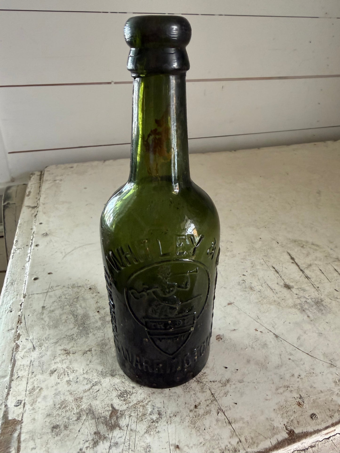 Antique Bottle dark green glass from Greenall Whitley & Co. of Warrington, England