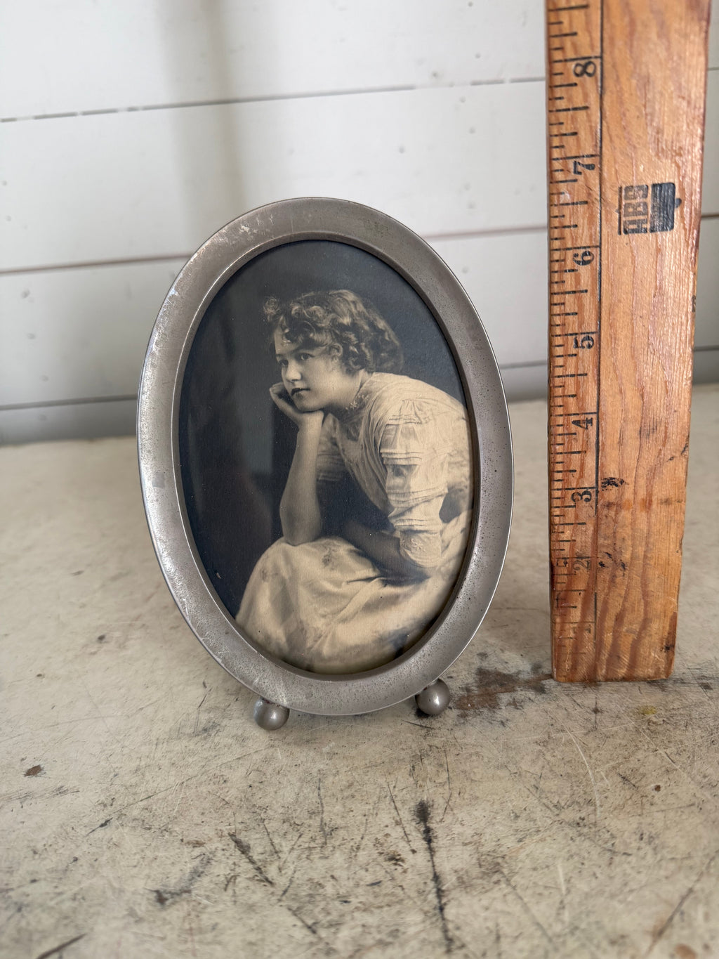 Vintage oval frame with black and white portrait of a woman