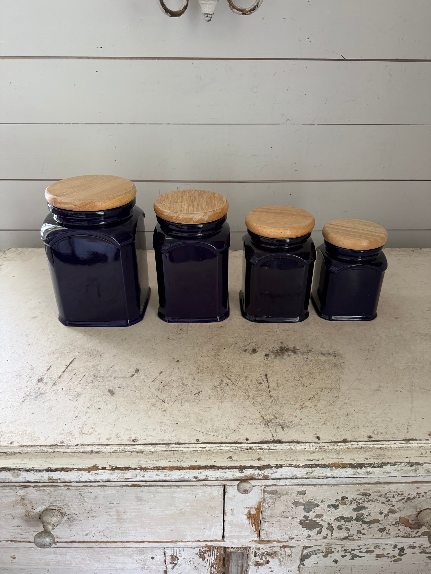 4 cobalt blue ceramic kitchen canisters with wooden lids