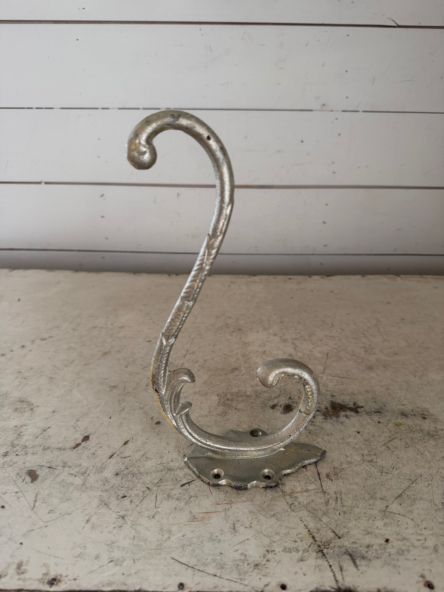 Silver colored, cast-iron hat, hook