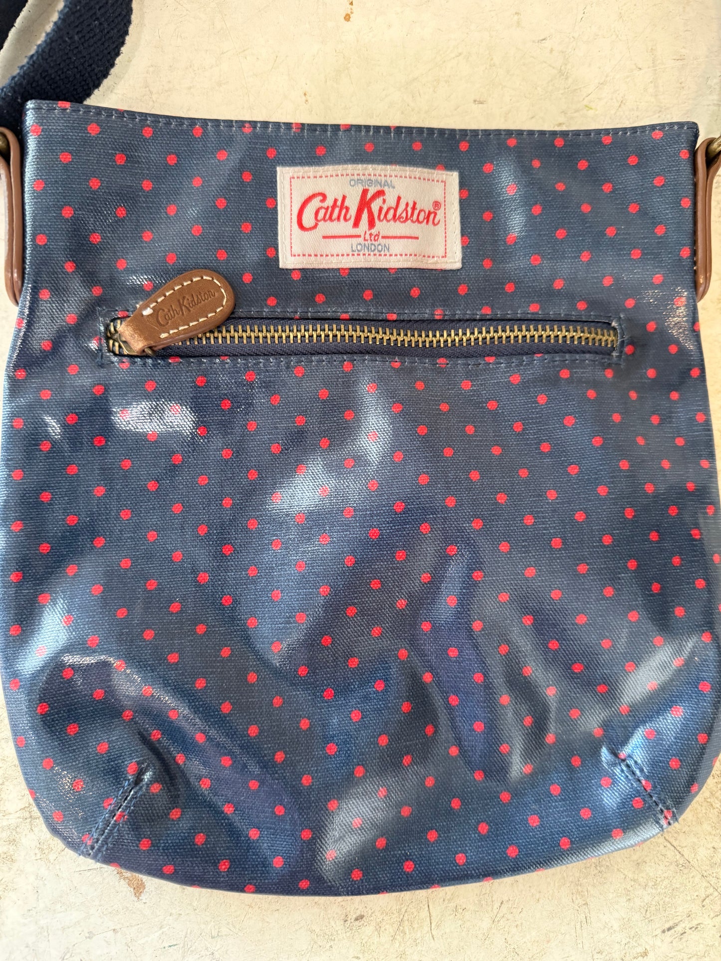 Cath Kidston bag with a navy blue and red polka dot print