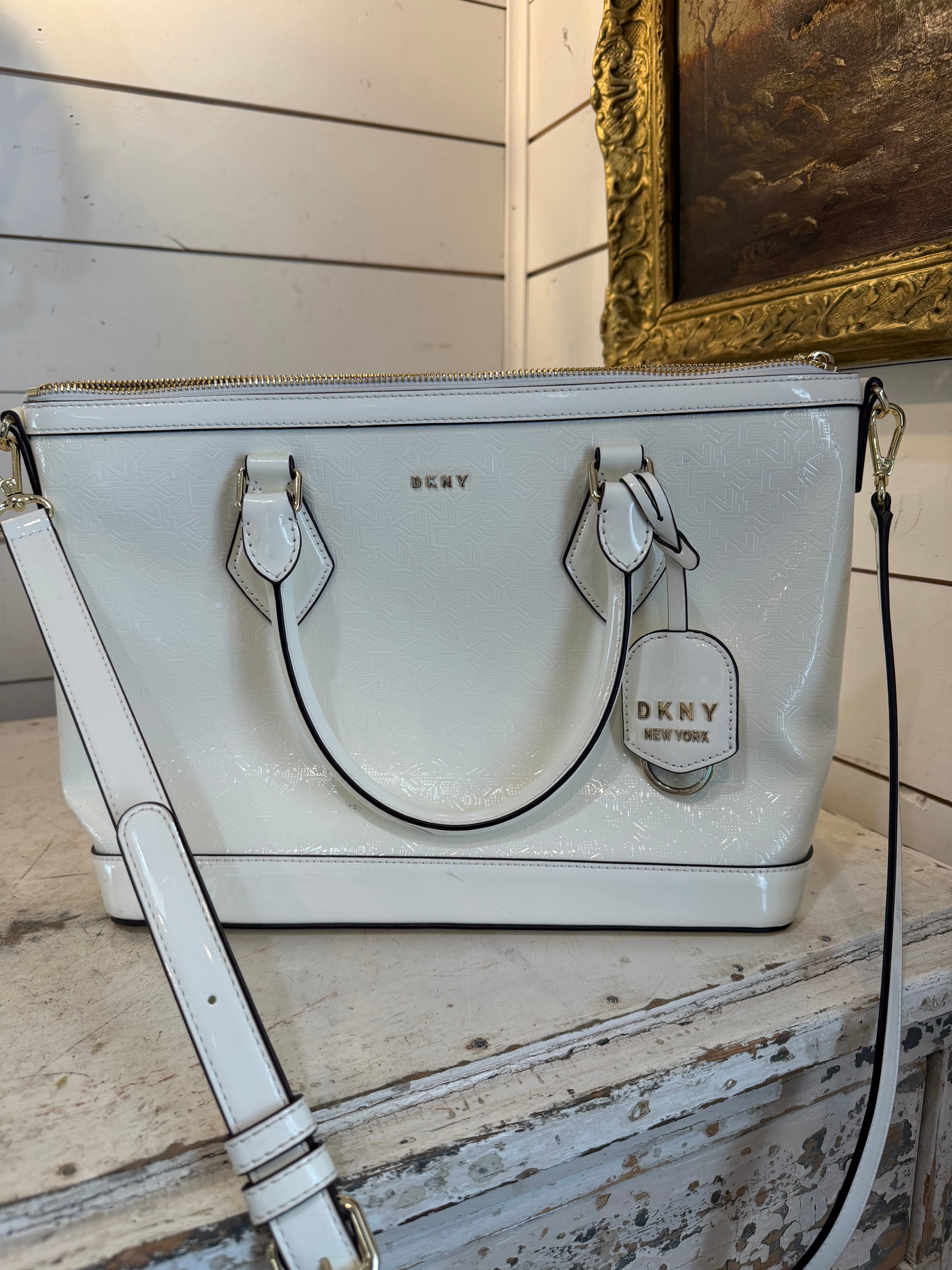 DKNY Hadlee small tote bag in a patent material with a removable shoulder strap has small scuffs