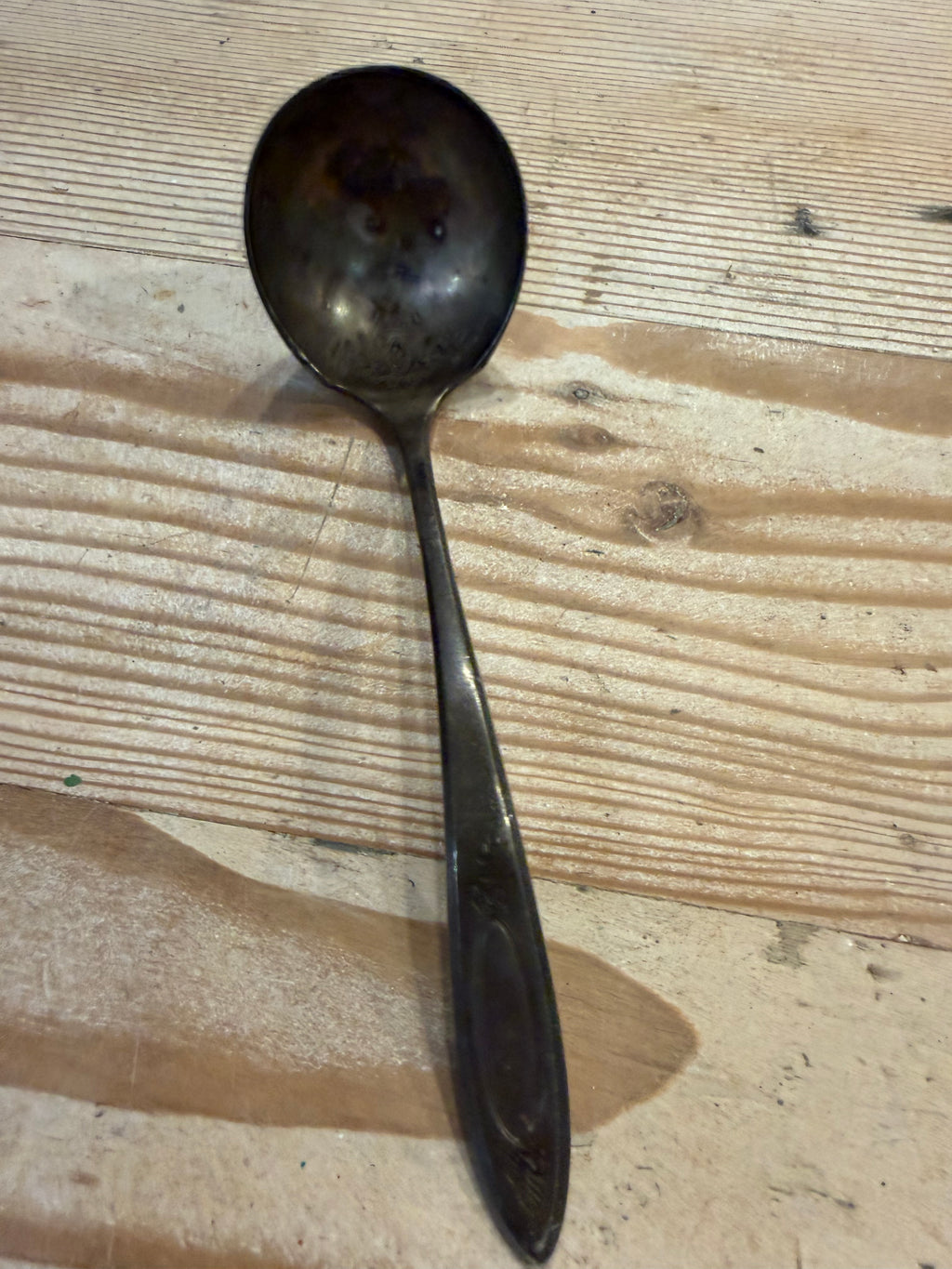 tarnished silver-plated ladle