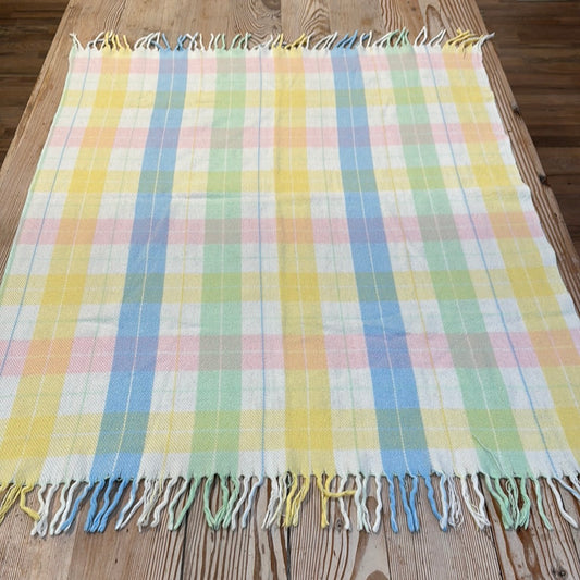 Pastel yellow, Pink, Blue, Green throw has small tear as pictured