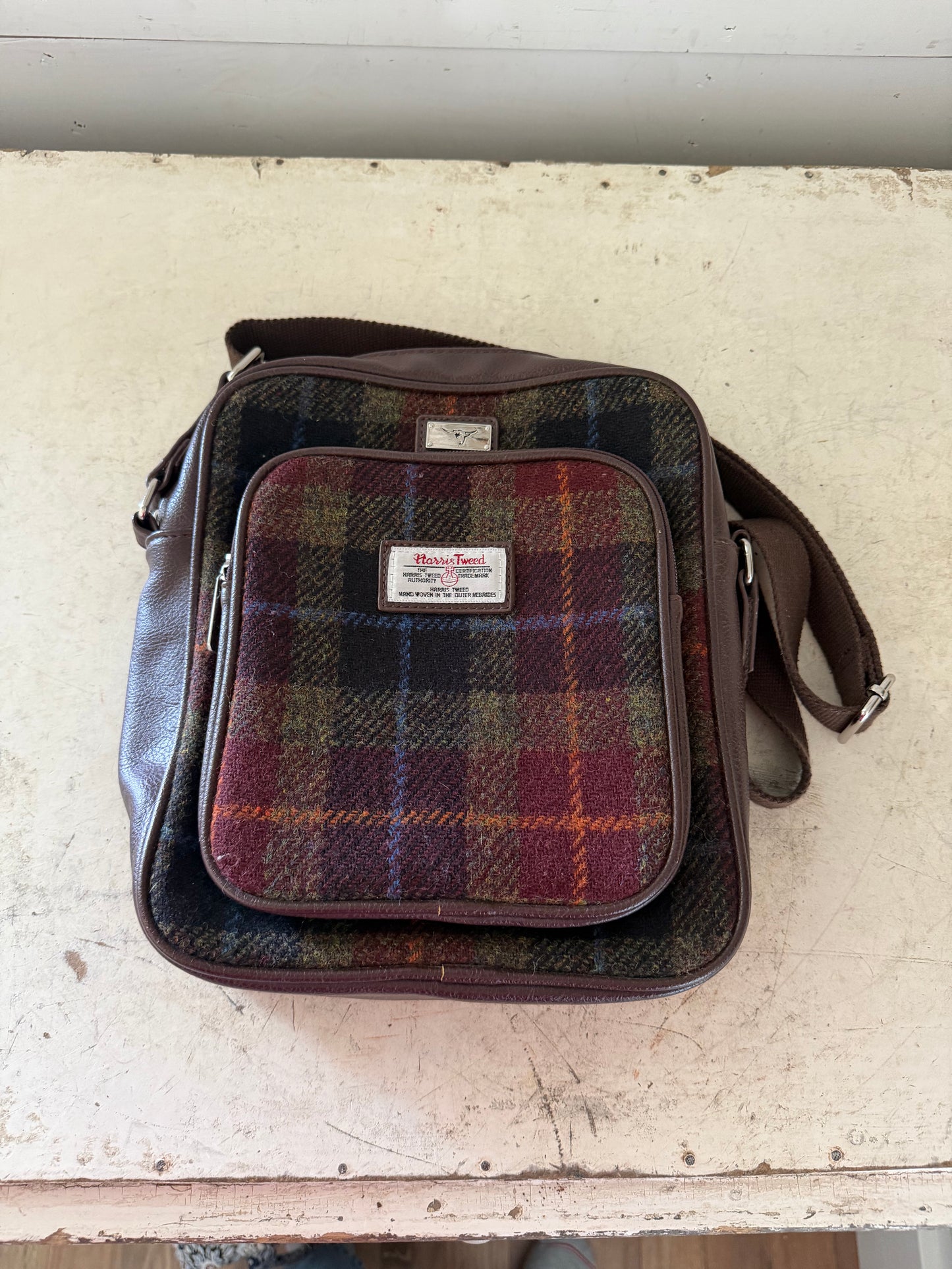 Glen Appin Harris Tweed Tay travel bag featuring a multi-colored tartan pattern and brown trim