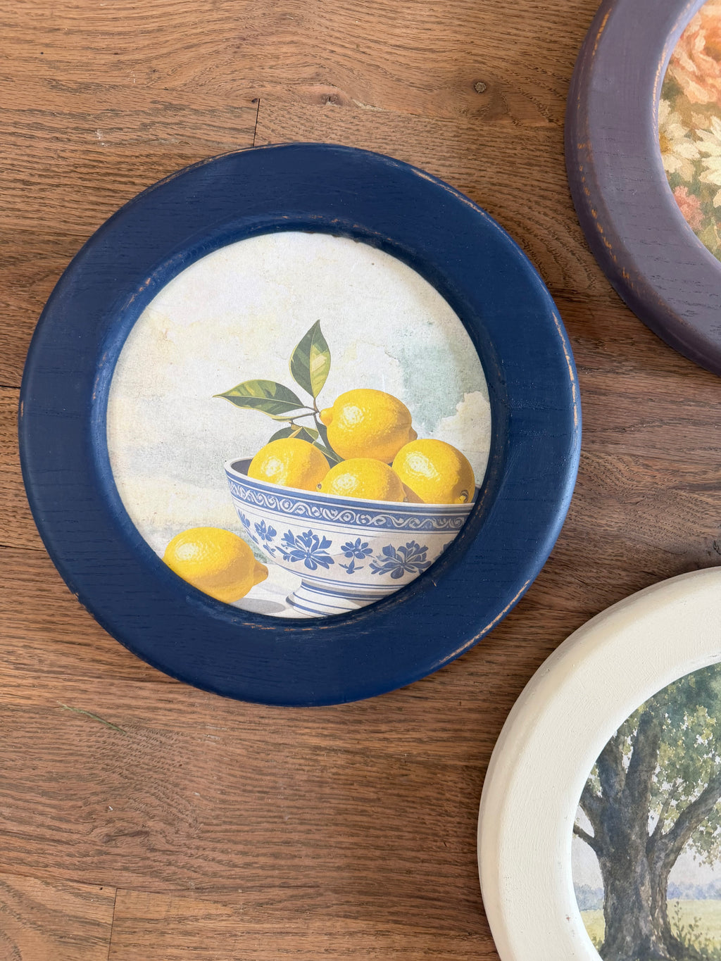Art in round wood hand painted frame 10.25”