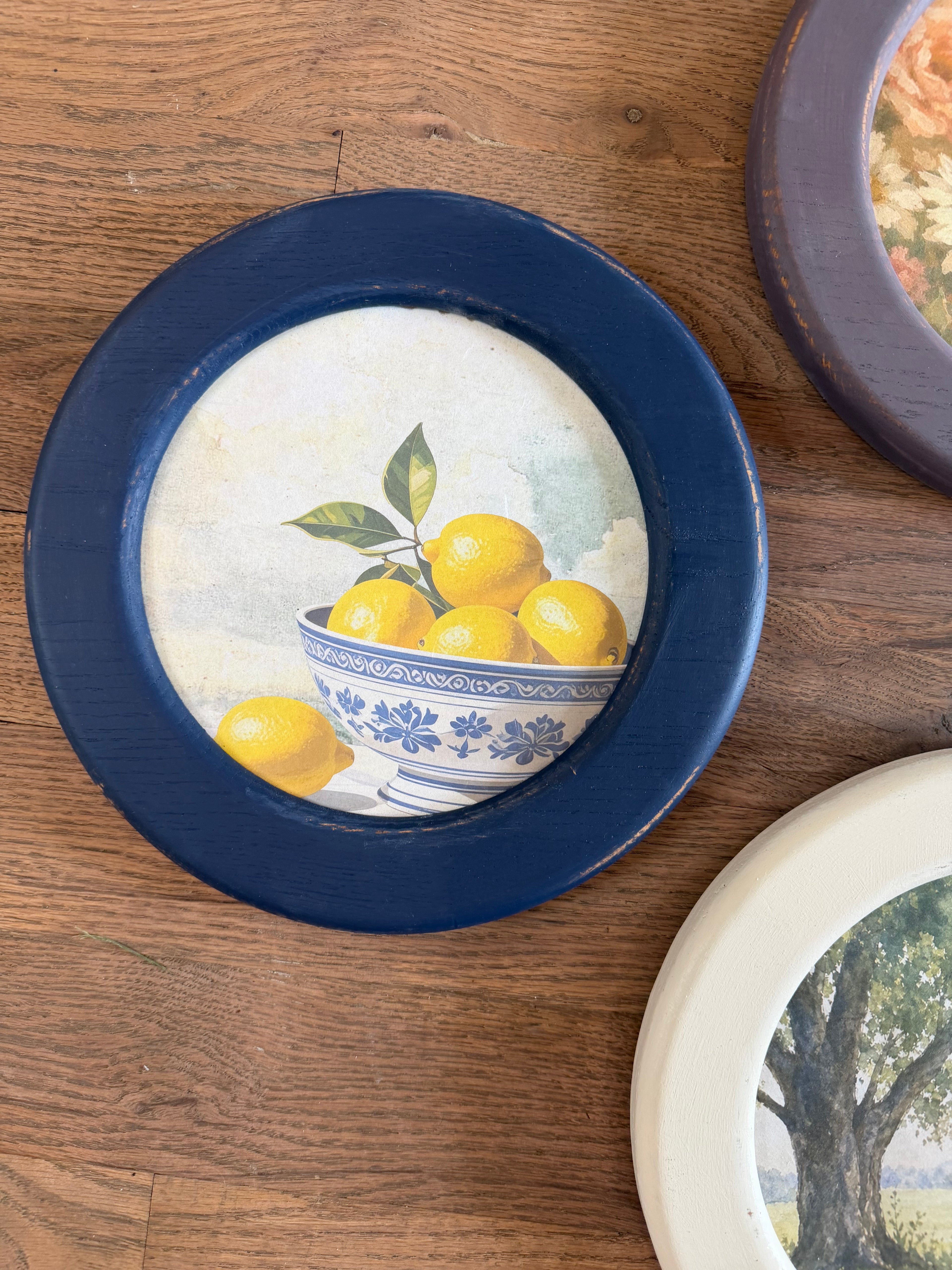Art in round wood hand painted frame 10.25”