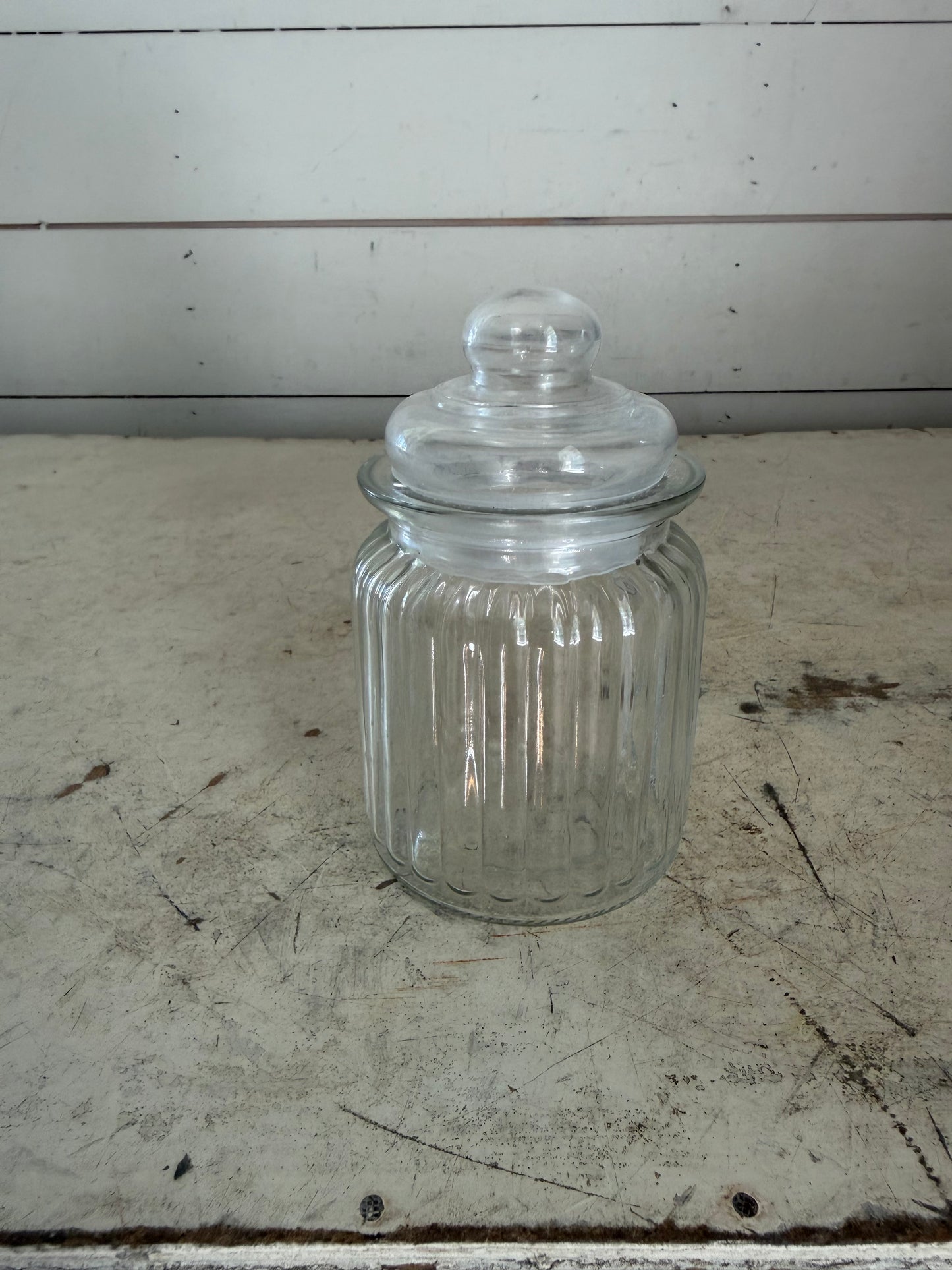 Clear, ribbed glass apothecary jar with lid