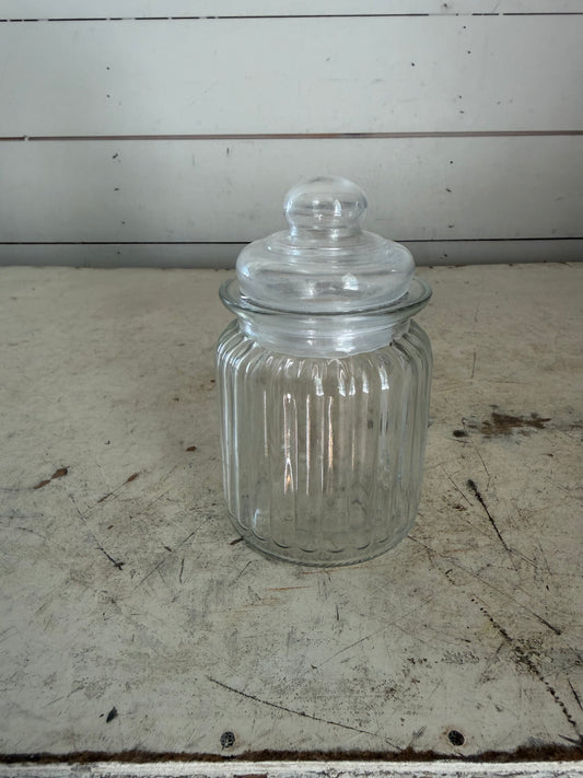 Clear, ribbed glass apothecary jar with lid