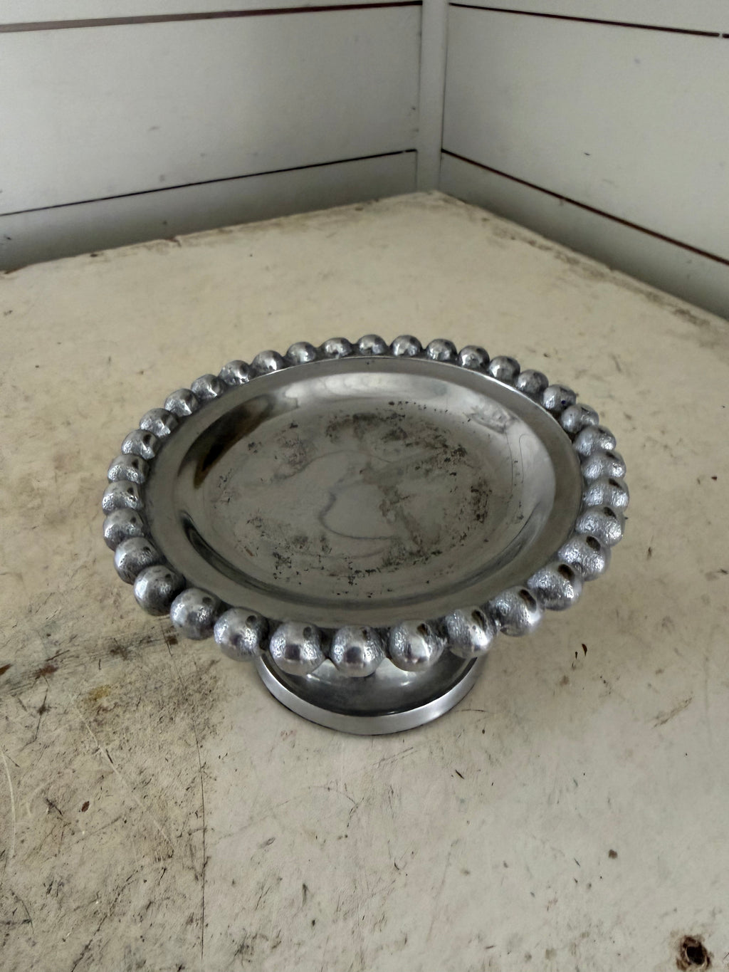 Beaded metal candle holder on pedestal