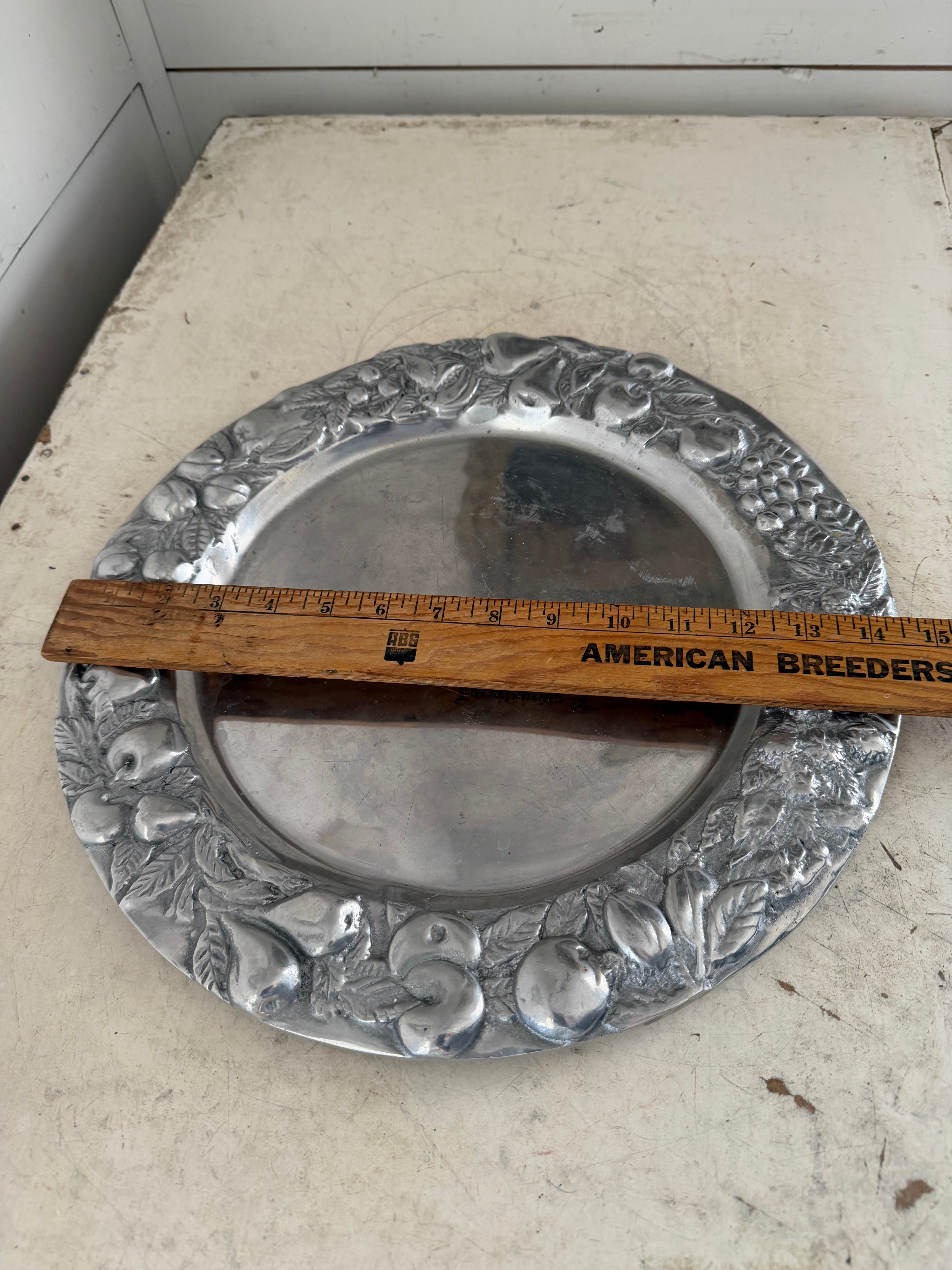 Mexican pewter / aluminum serving platter with a fruit and vine motif.