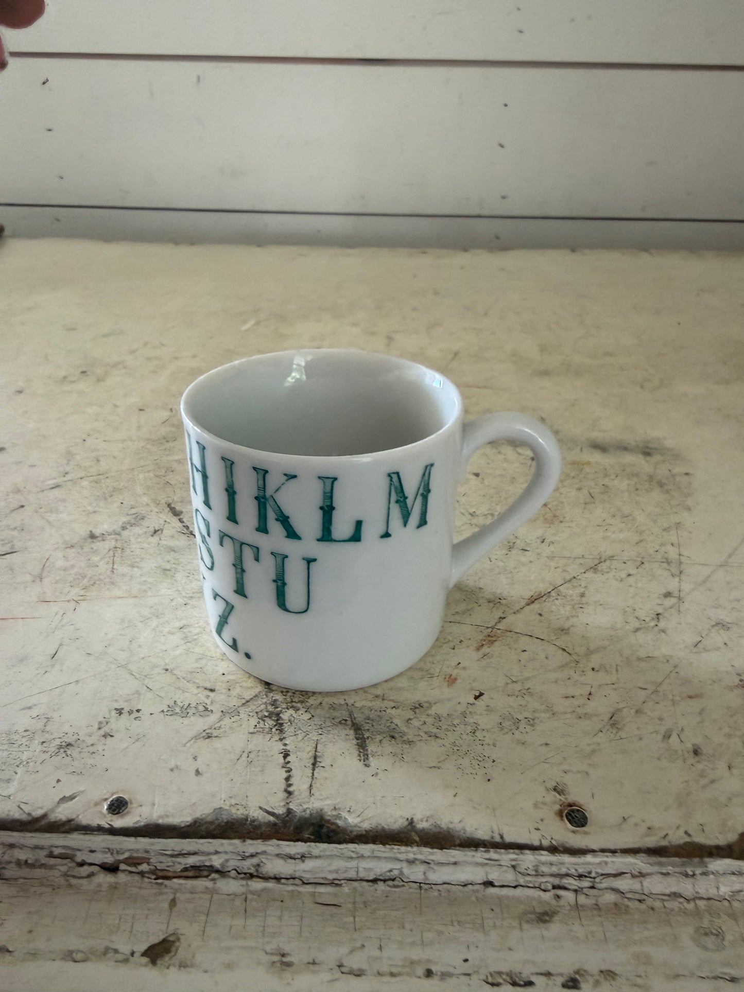 Vintage German porcelain alphabet mug featuring dark green transferware lettering