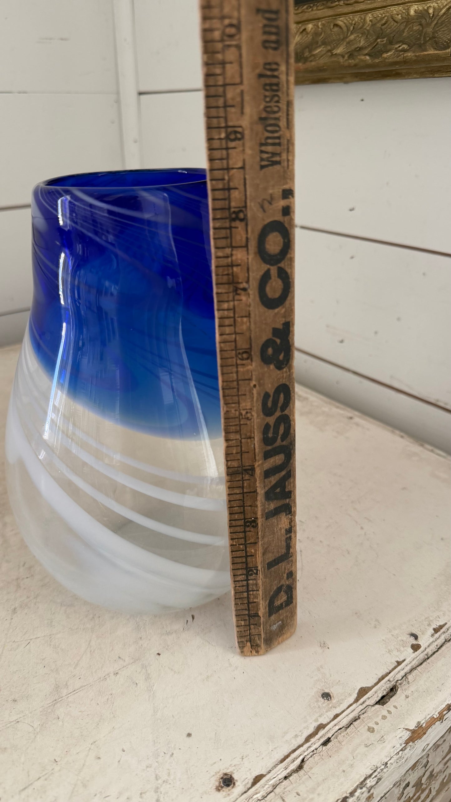 vintage studio hand-blown art glass vase featuring a striking cobalt blue top half that gradients into a clear base wrapped in opaque white swirls