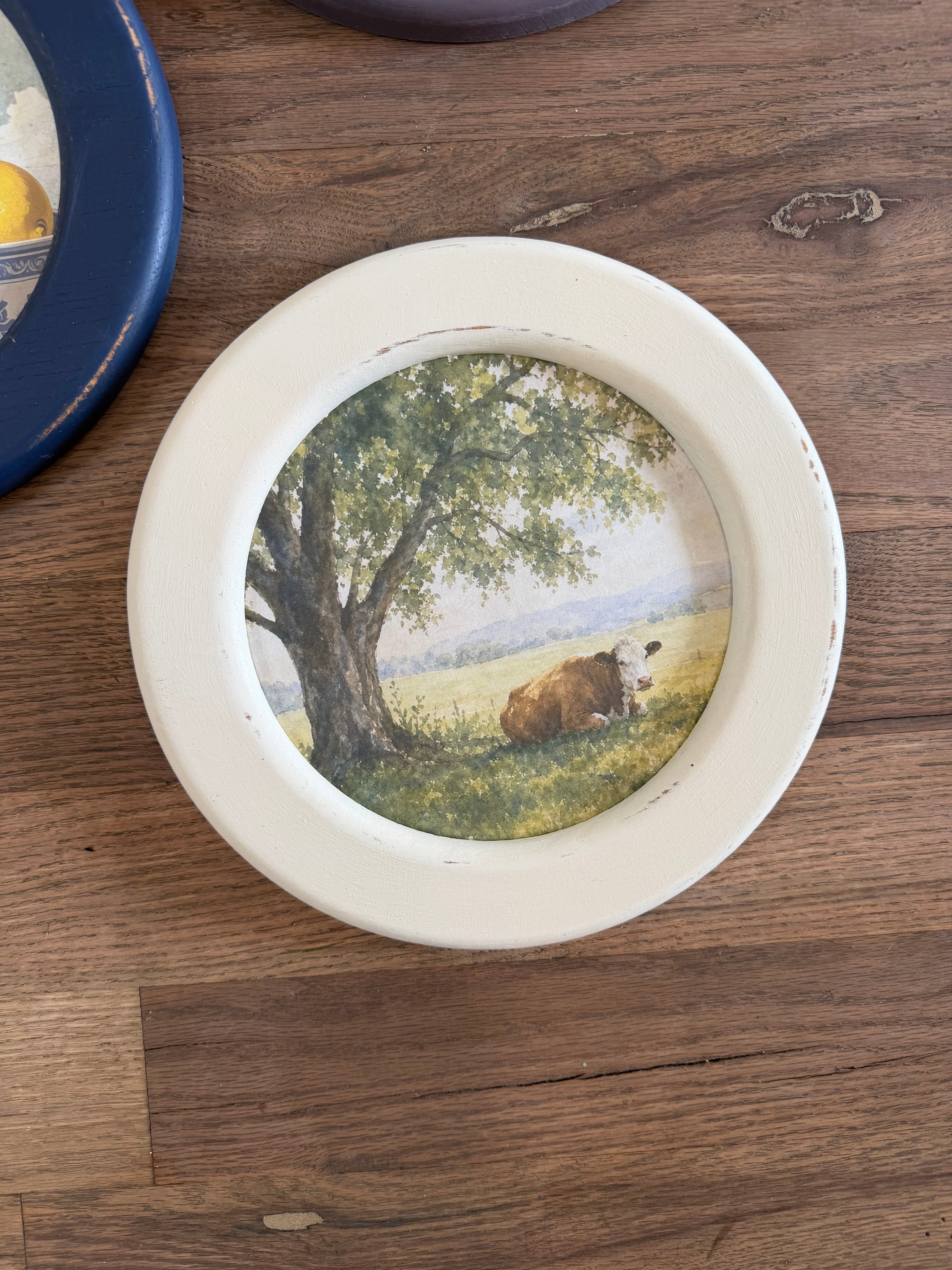 Art in round wood hand painted frame 10.25”