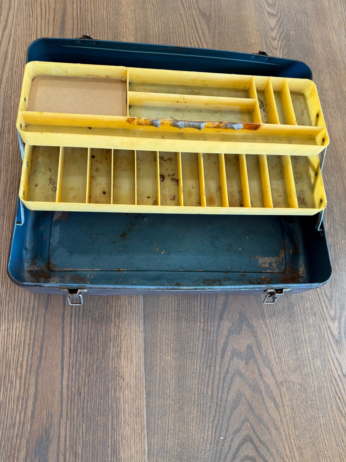 Vintage metal tackle box has dents and wear consistent with Age