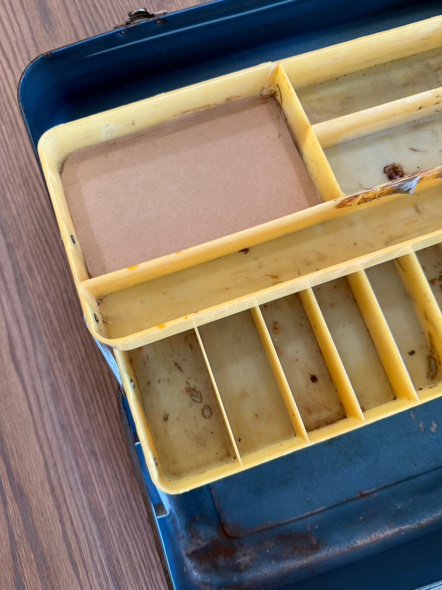 Vintage metal tackle box has dents and wear consistent with Age