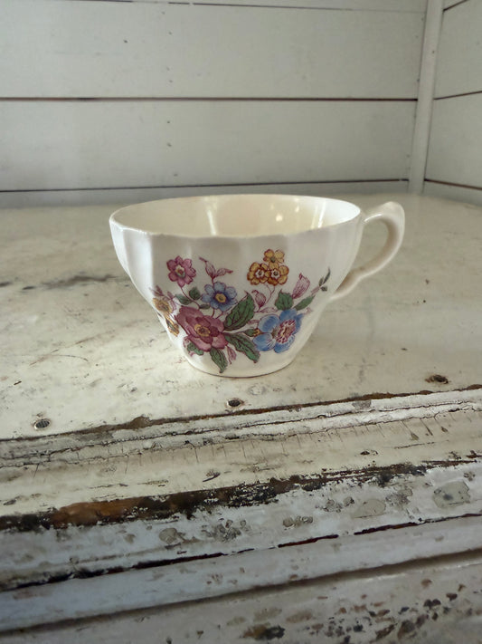 Vintage teacup in the "Romney" pattern, featuring a colorful floral design on a Gadroon-shaped white body