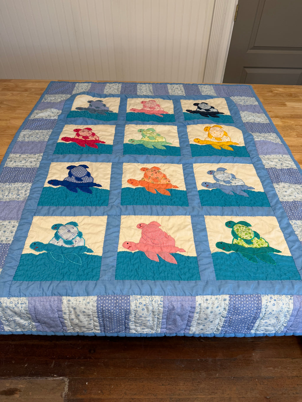Handcrafted sea turtle-themed baby quilt