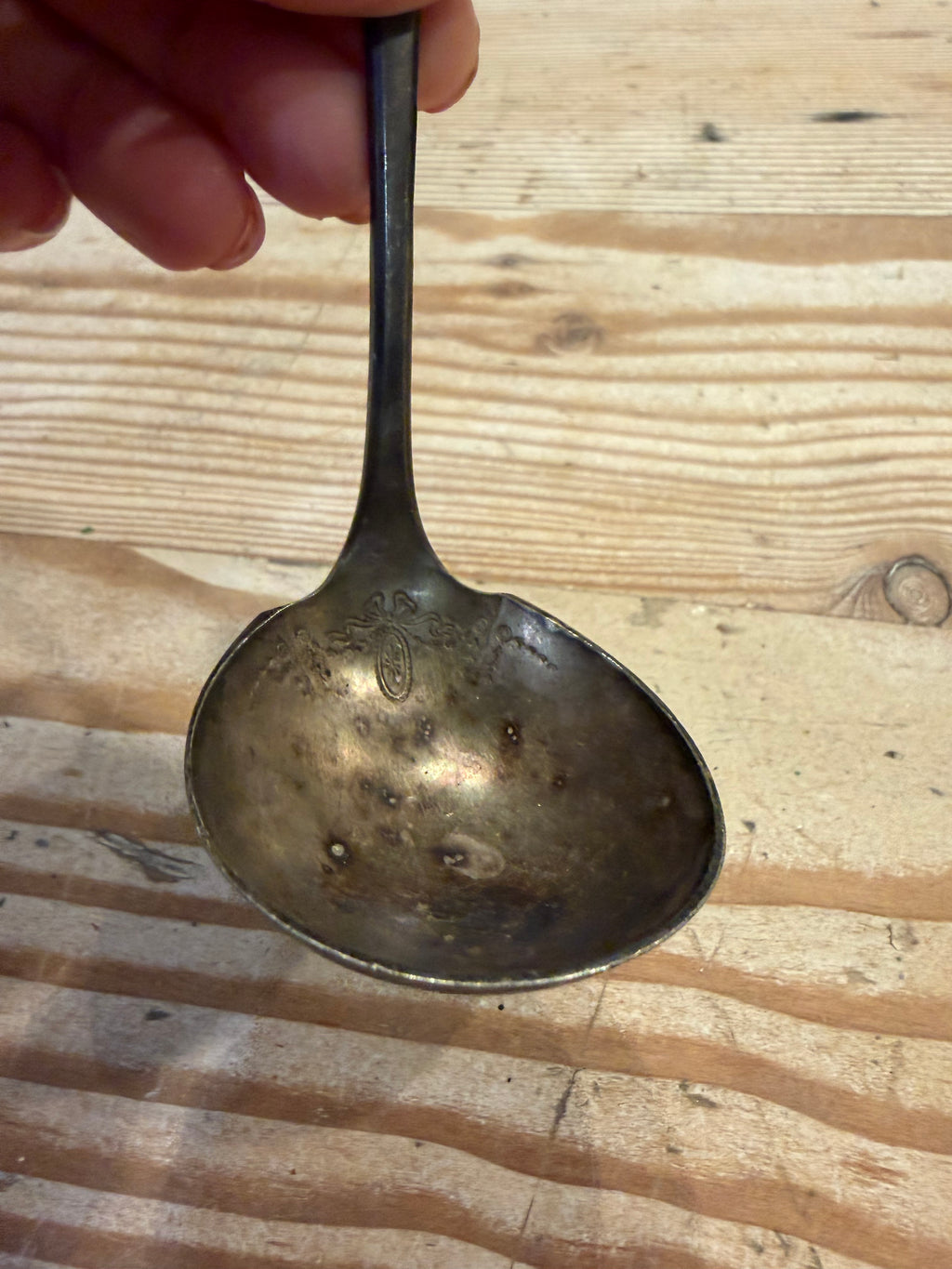 tarnished silver-plated ladle
