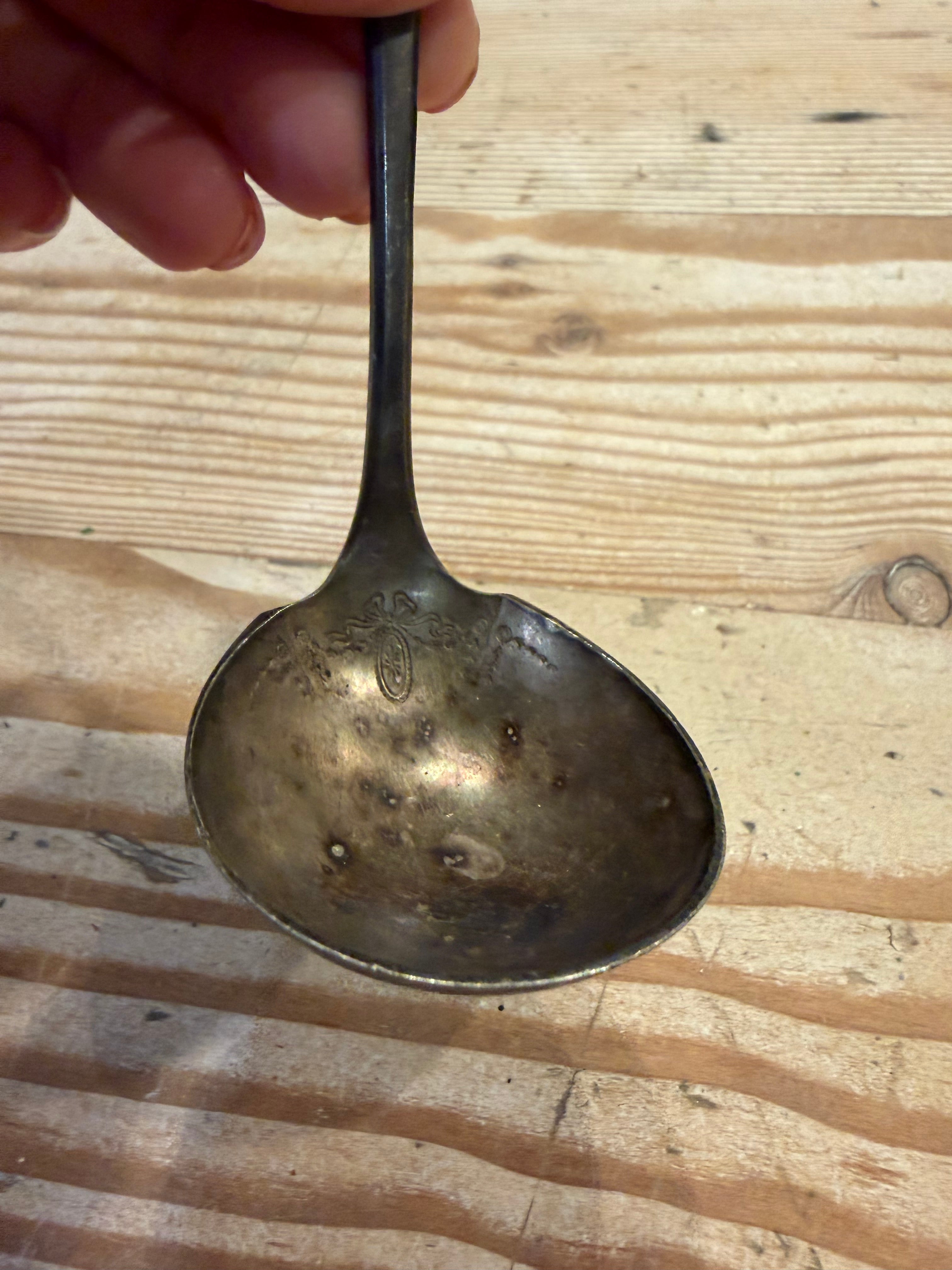 tarnished silver-plated ladle