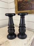 Set of black distress turned candlesticks