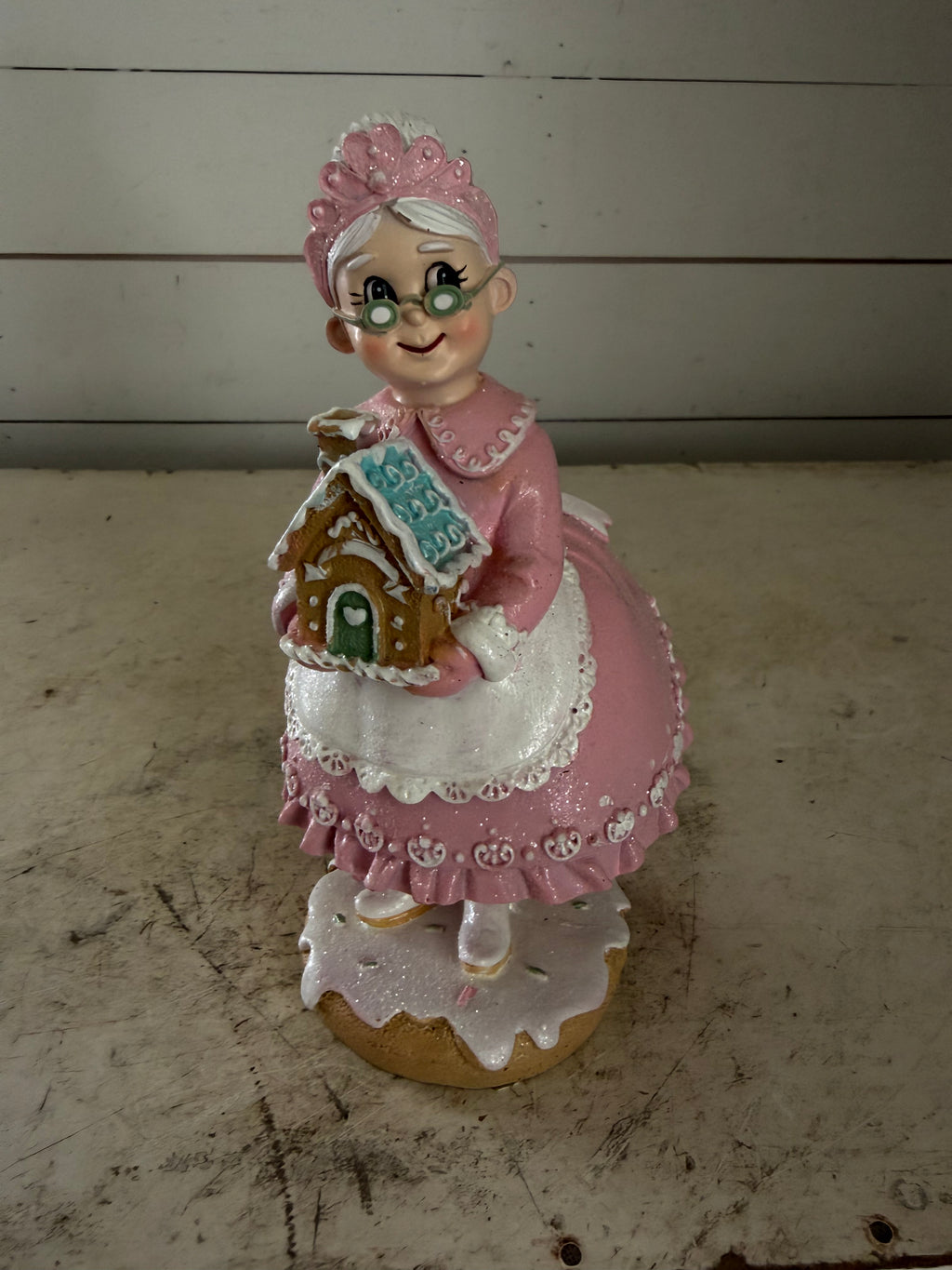 Mrs. Claus Holding Gingerbread House
