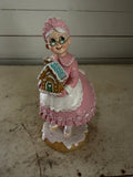 Mrs. Claus Holding Gingerbread House