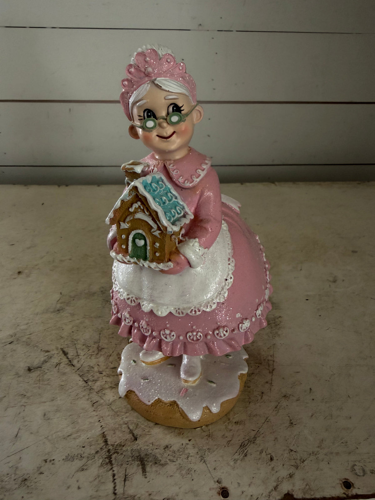 Mrs. Claus Holding Gingerbread House