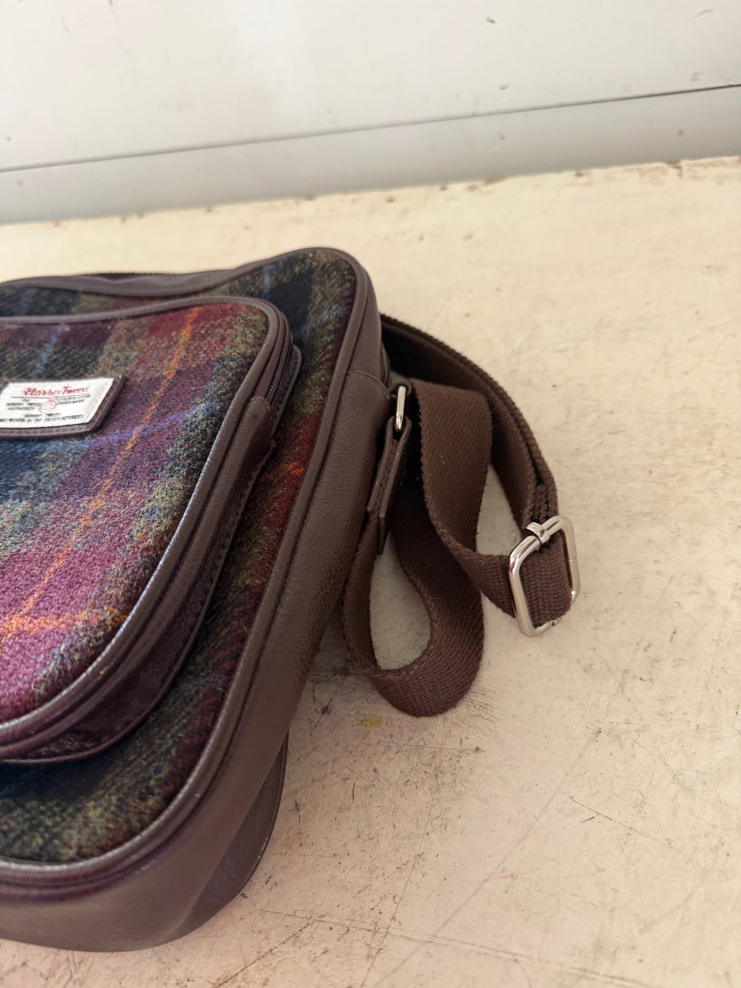 Glen Appin Harris Tweed Tay travel bag featuring a multi-colored tartan pattern and brown trim