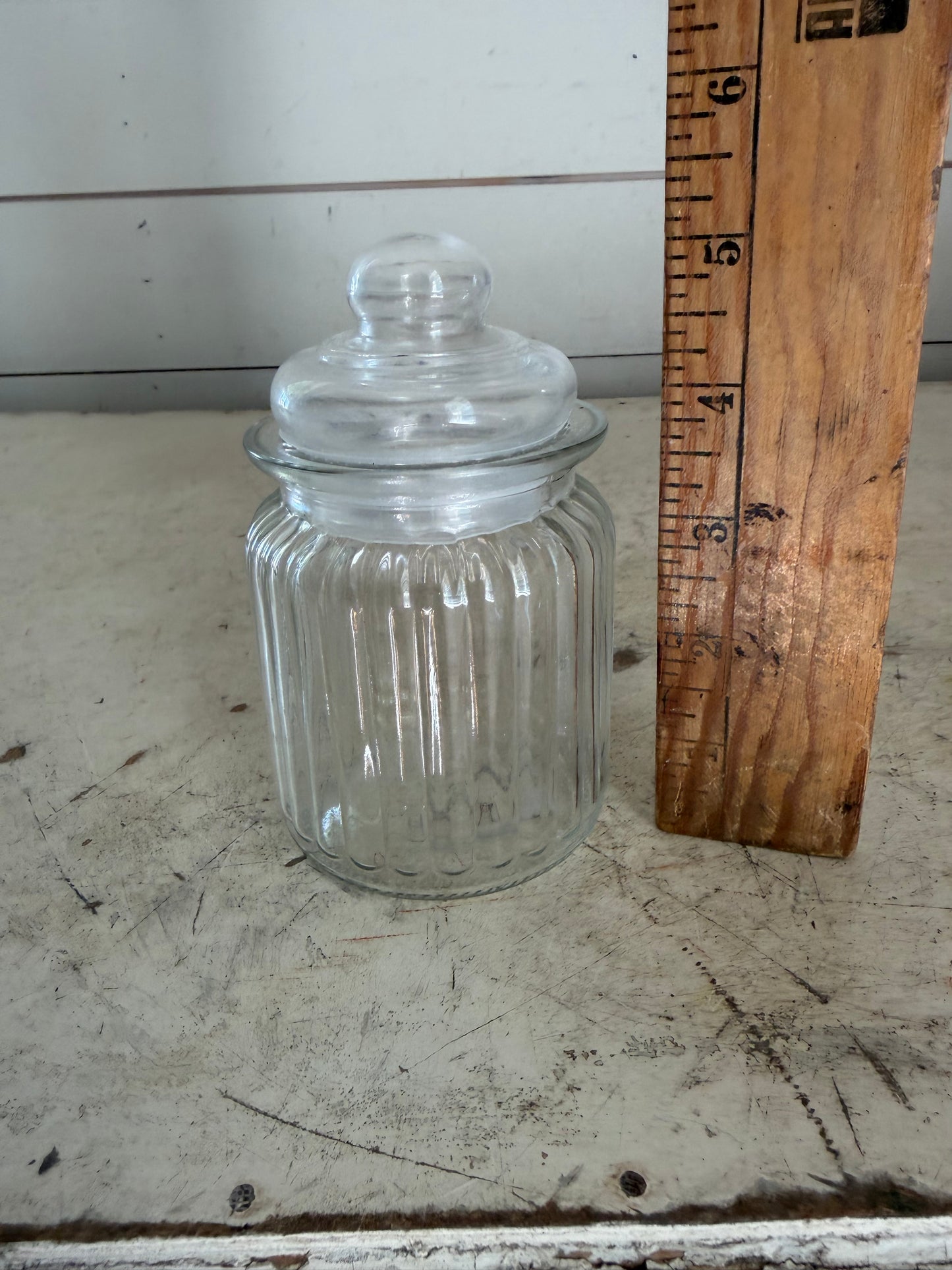 Clear, ribbed glass apothecary jar with lid