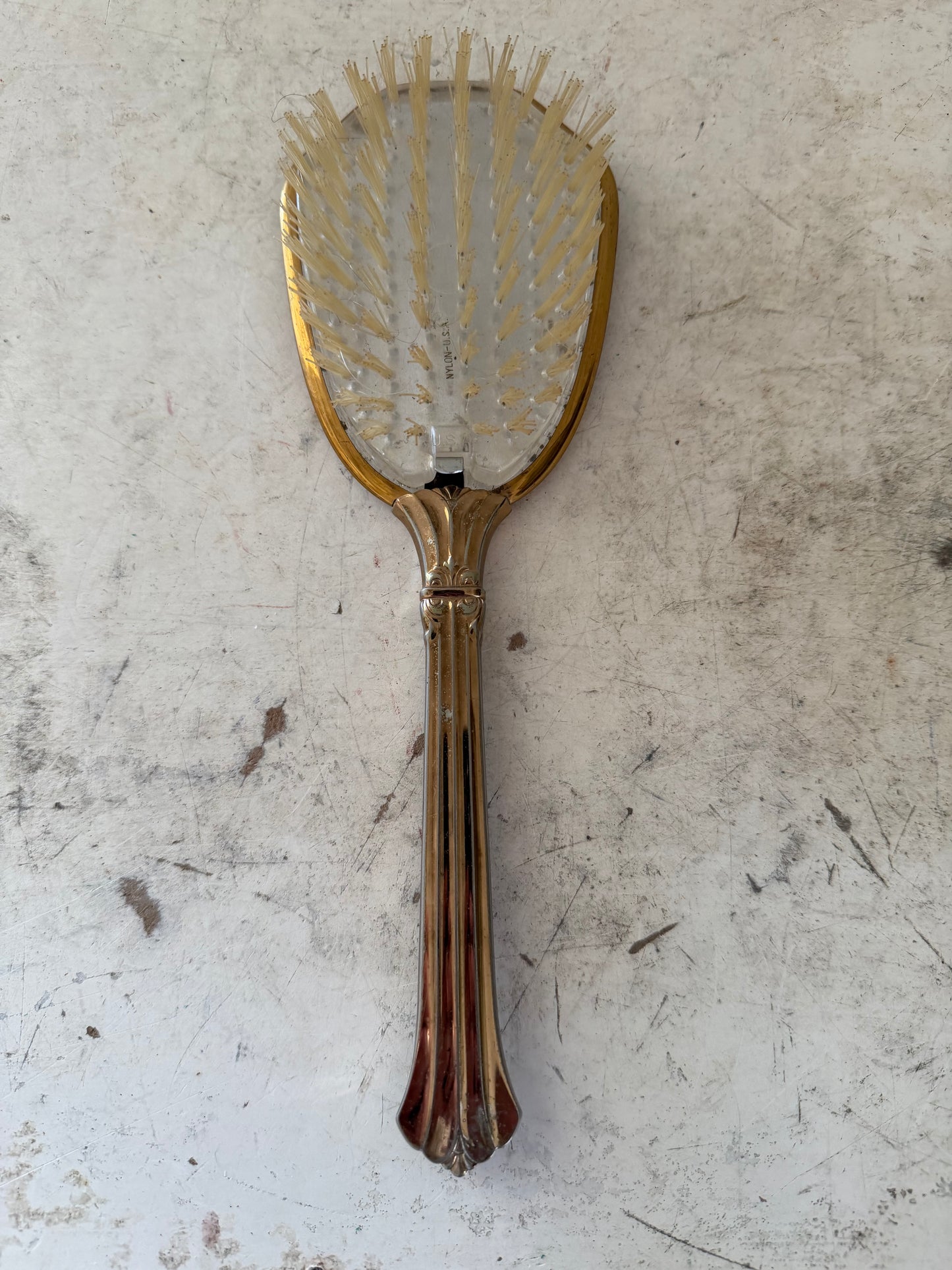 Vintage gold tone hair brush