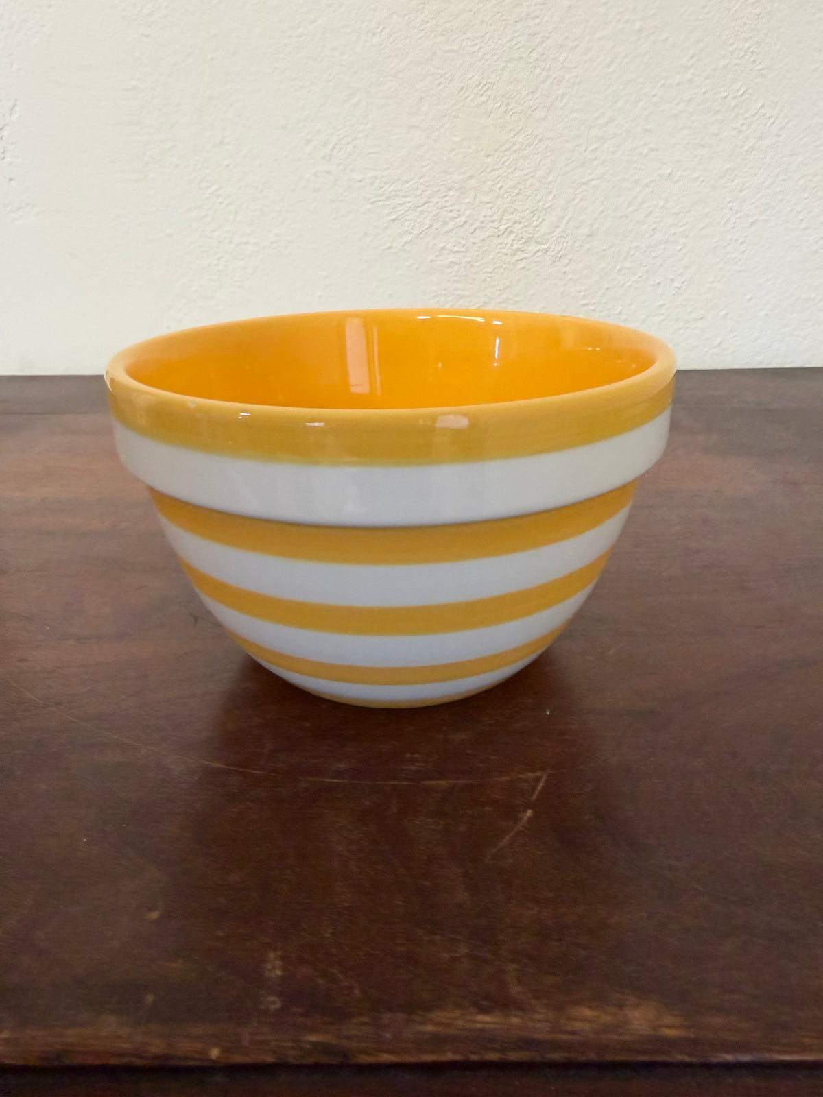 Yellow and white ceramic striped bowl