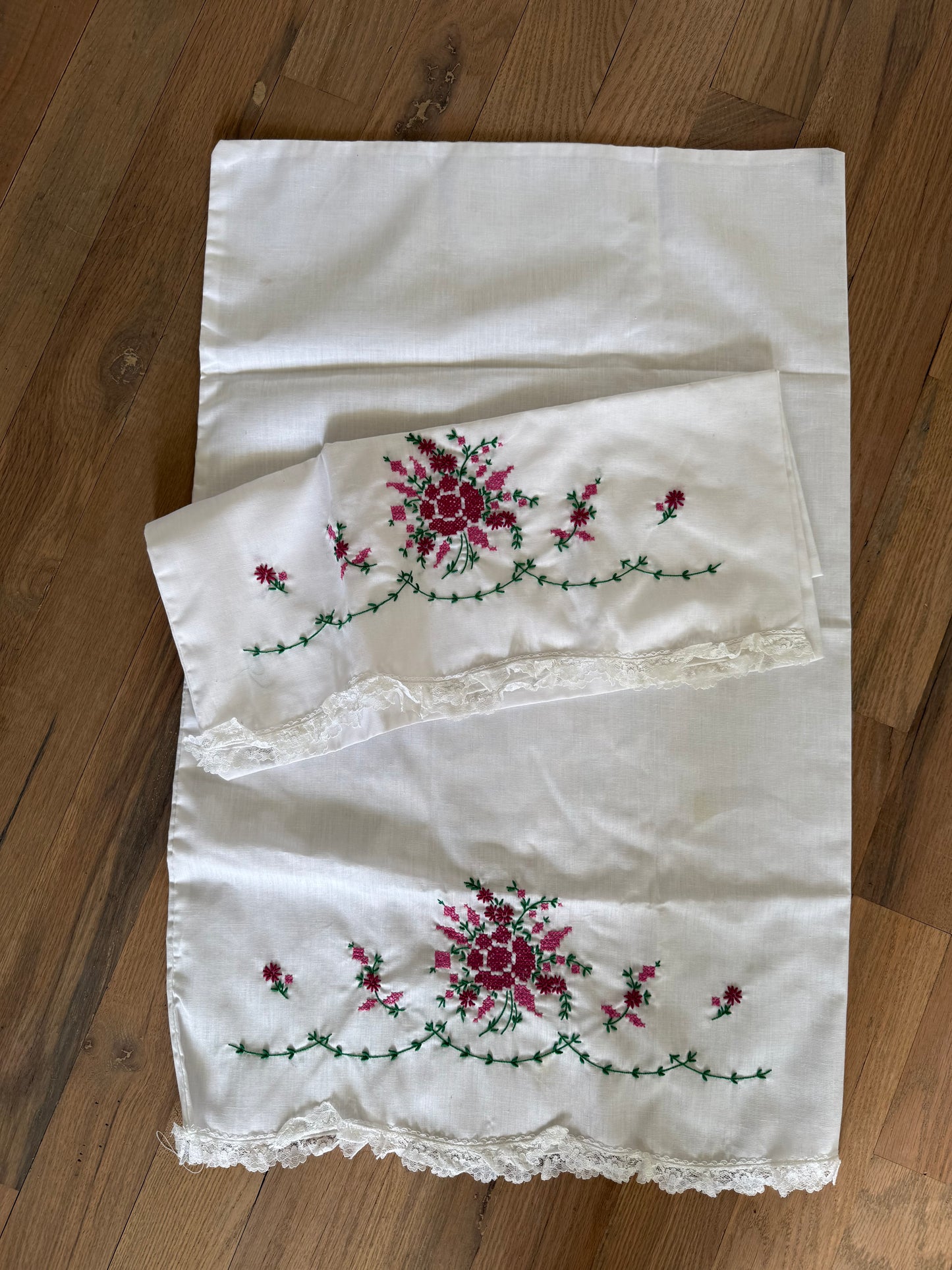 Set of Standard hand-embroidered floral pillow cases with lace trim