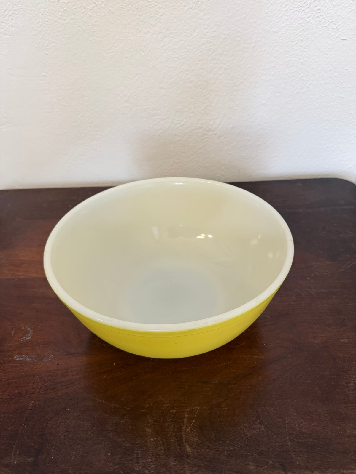Vintage yellow Pyrex Mixing Bowl with a white interior - Has Some Wear