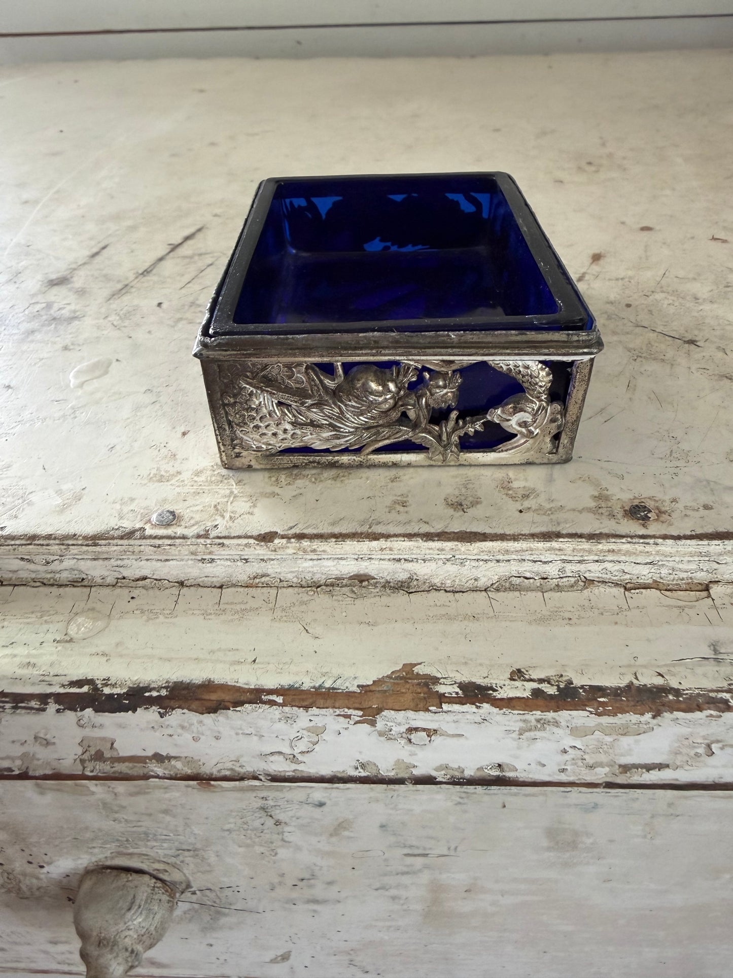 Vintage dragon themed trinket holder with cobalt blue glass insert