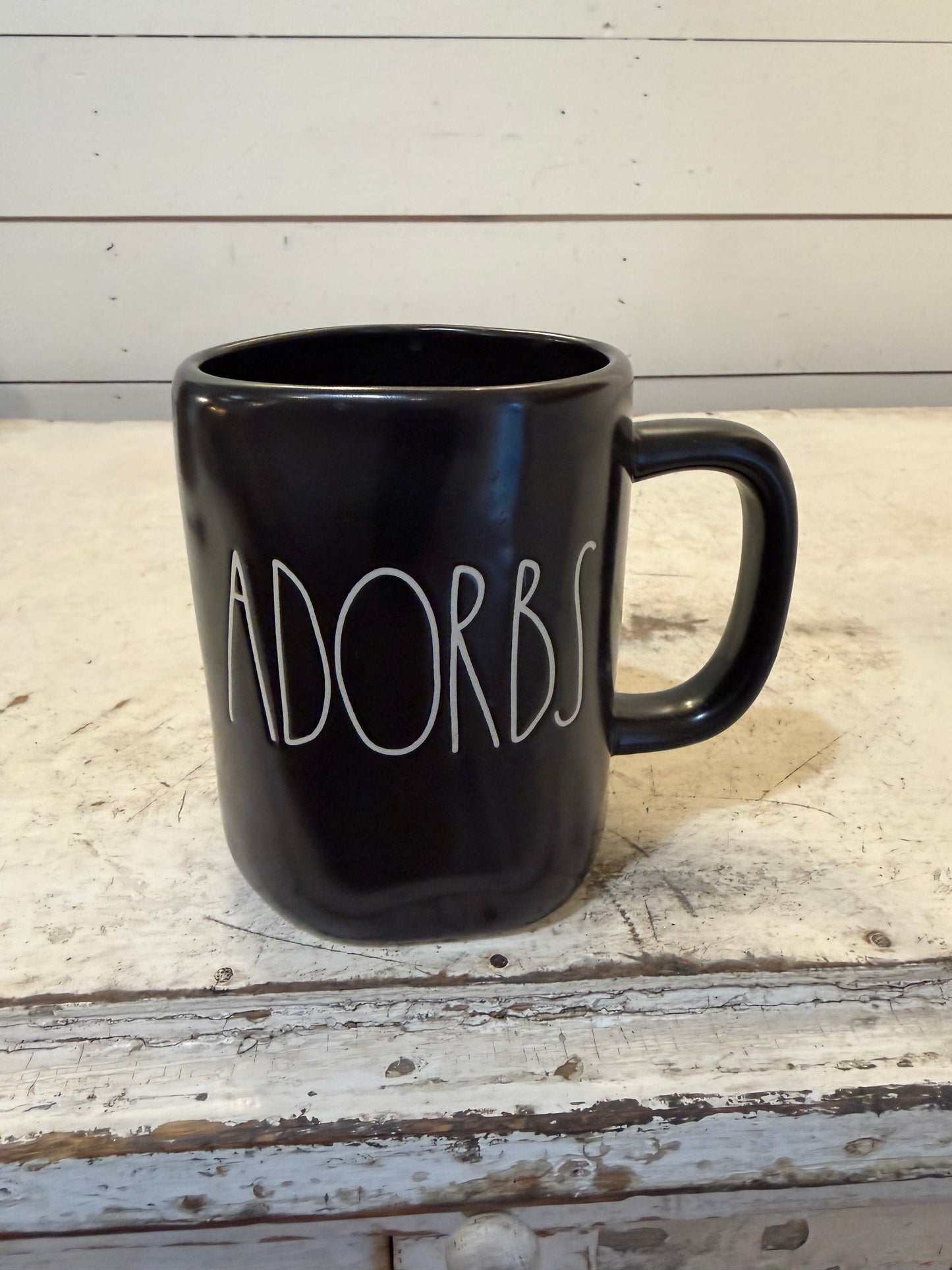 Rae Dunn "ADORBS" black ceramic mug.