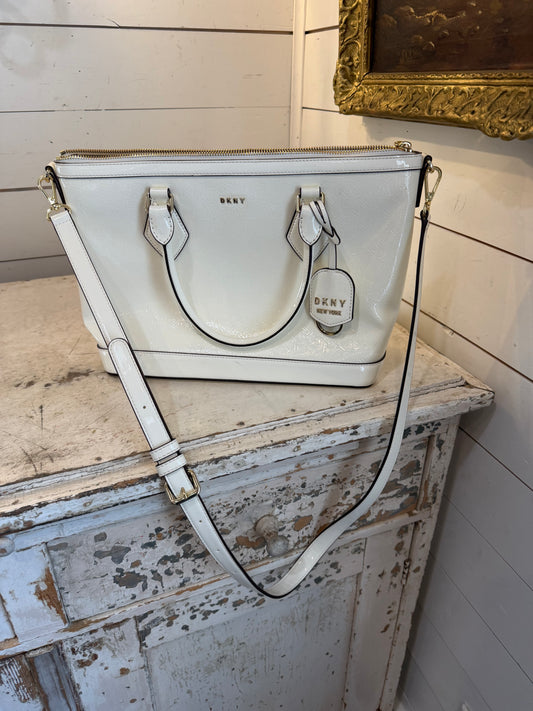 DKNY Hadlee small tote bag in a patent material with a removable shoulder strap has small scuffs