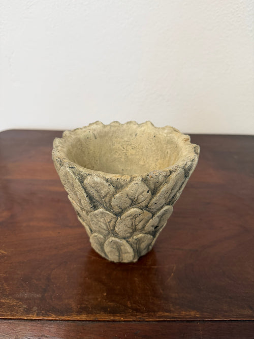 Maceta de cemento con diseño de hojas