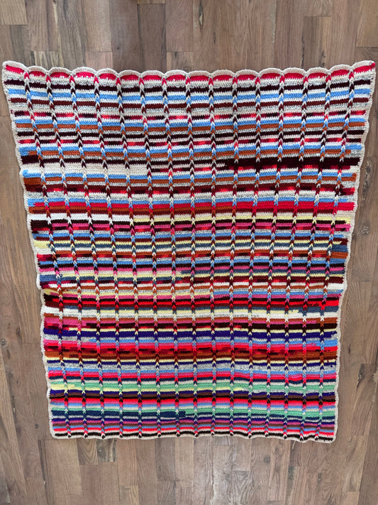 White brown and red striped afghan