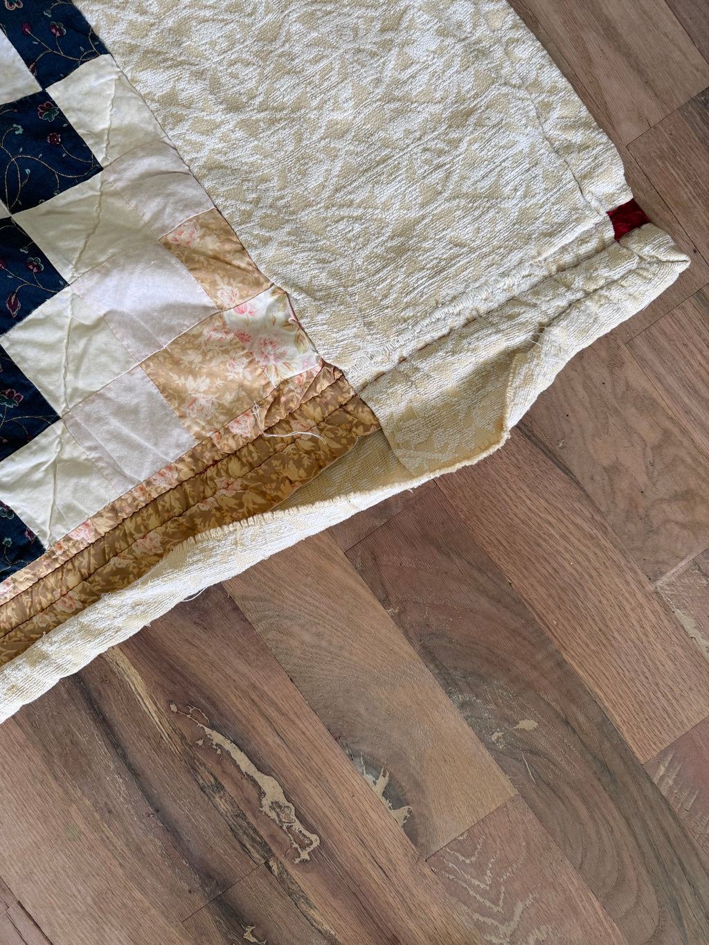 Hand made quilt with diamond pattern - has rips