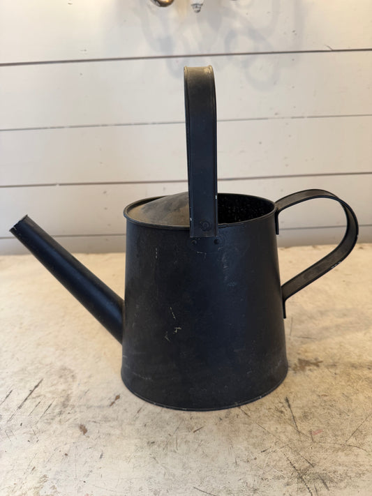 Black metal watering can will get transfer