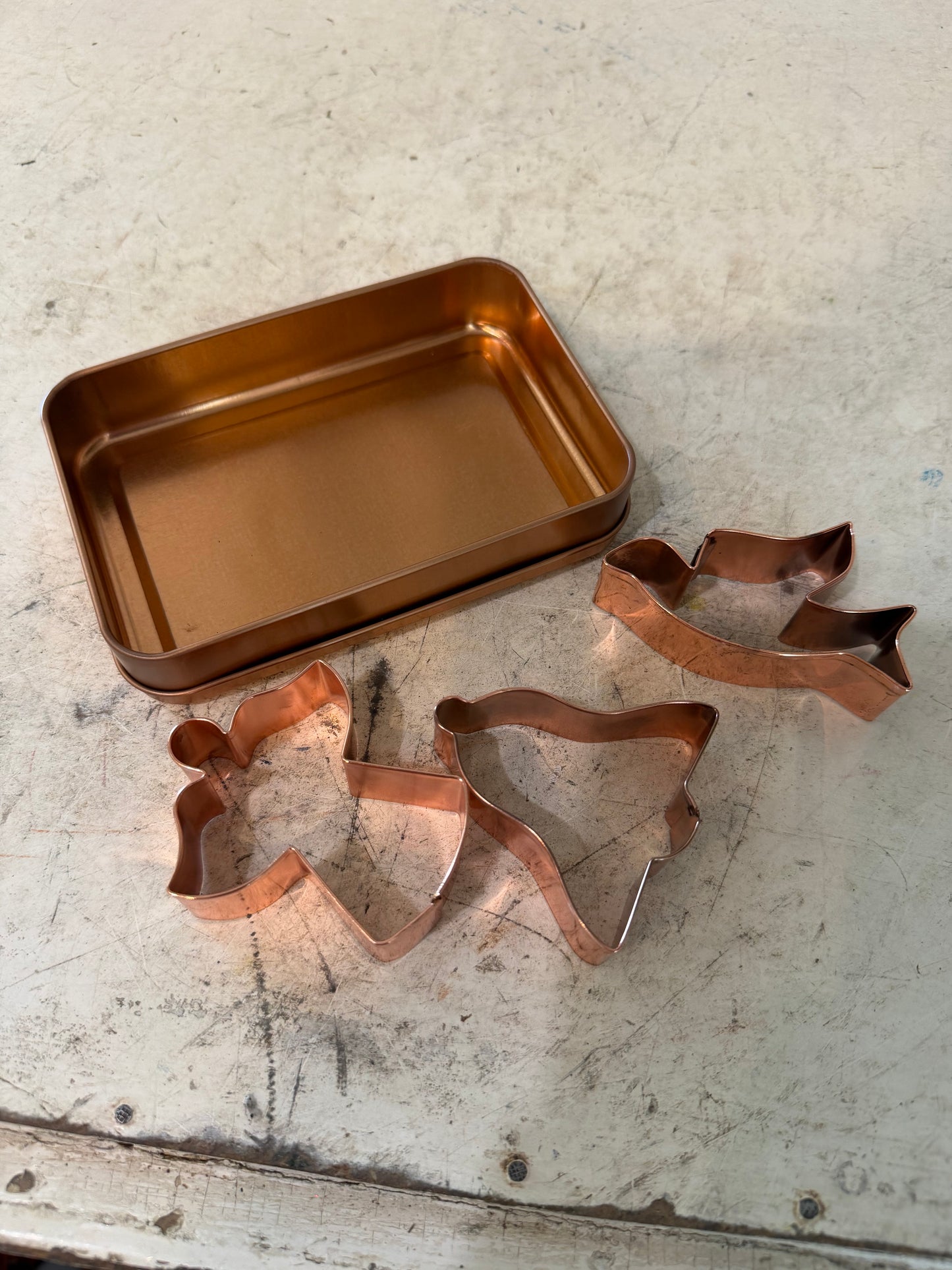 Set of copper Christmas cookie cutters in copper box